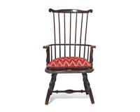 A Turned and Black-Painted Comb-Back Windsor Armchair