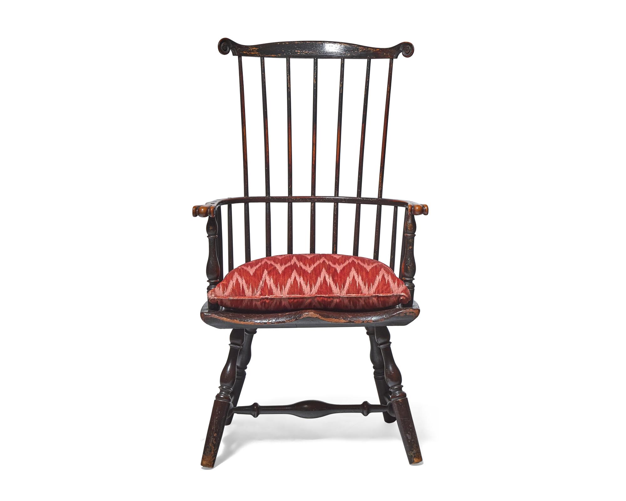 A Turned and Black-Painted Comb-Back Windsor Armchair