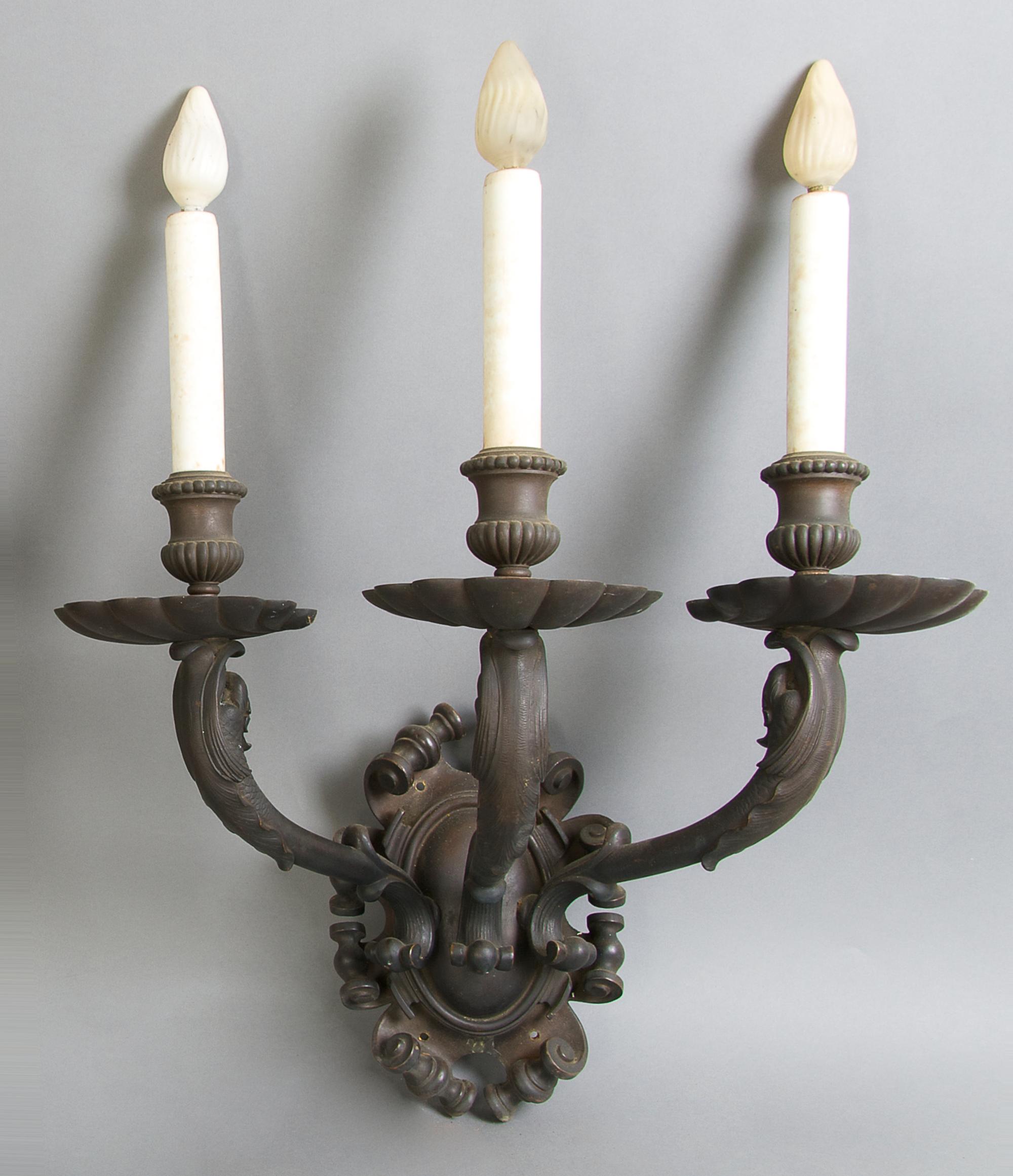 A Set of Four Neoclassical Three-Light Sconces, Caldwell, Height 15 1/2 inches.