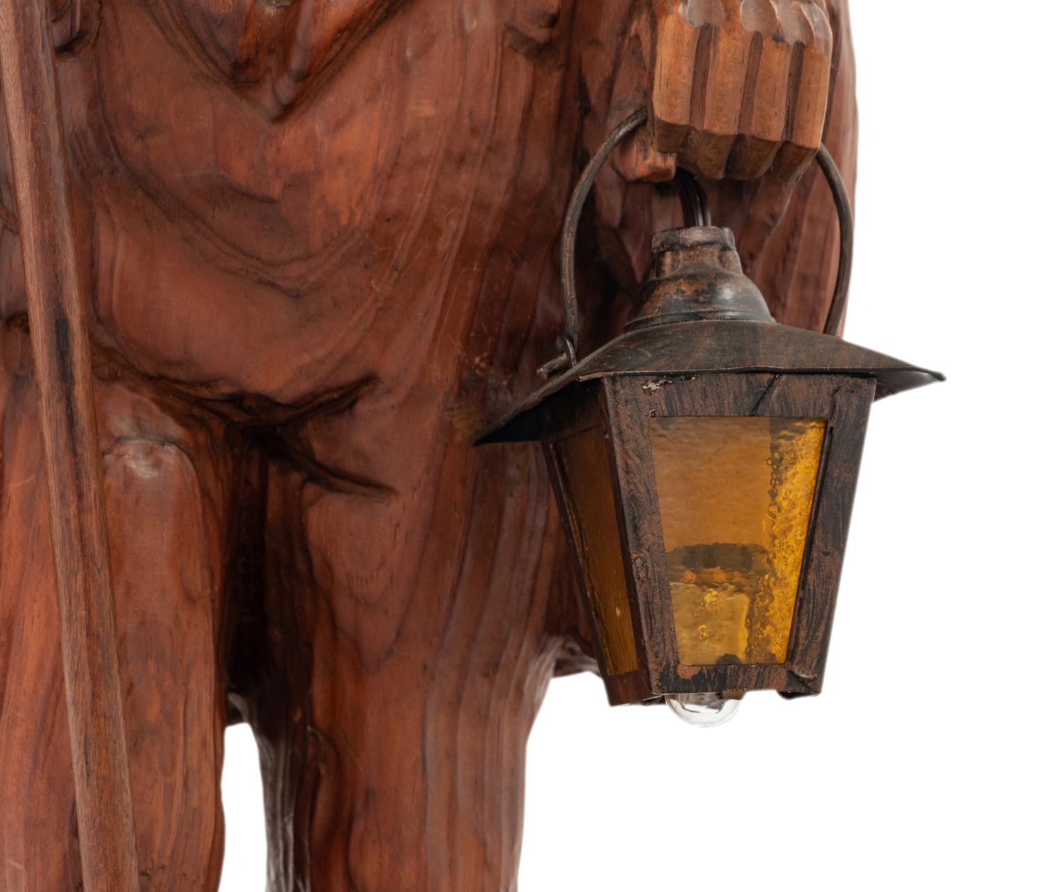 A Black Forest Carved Walnut 'Night Watchman' Lamp