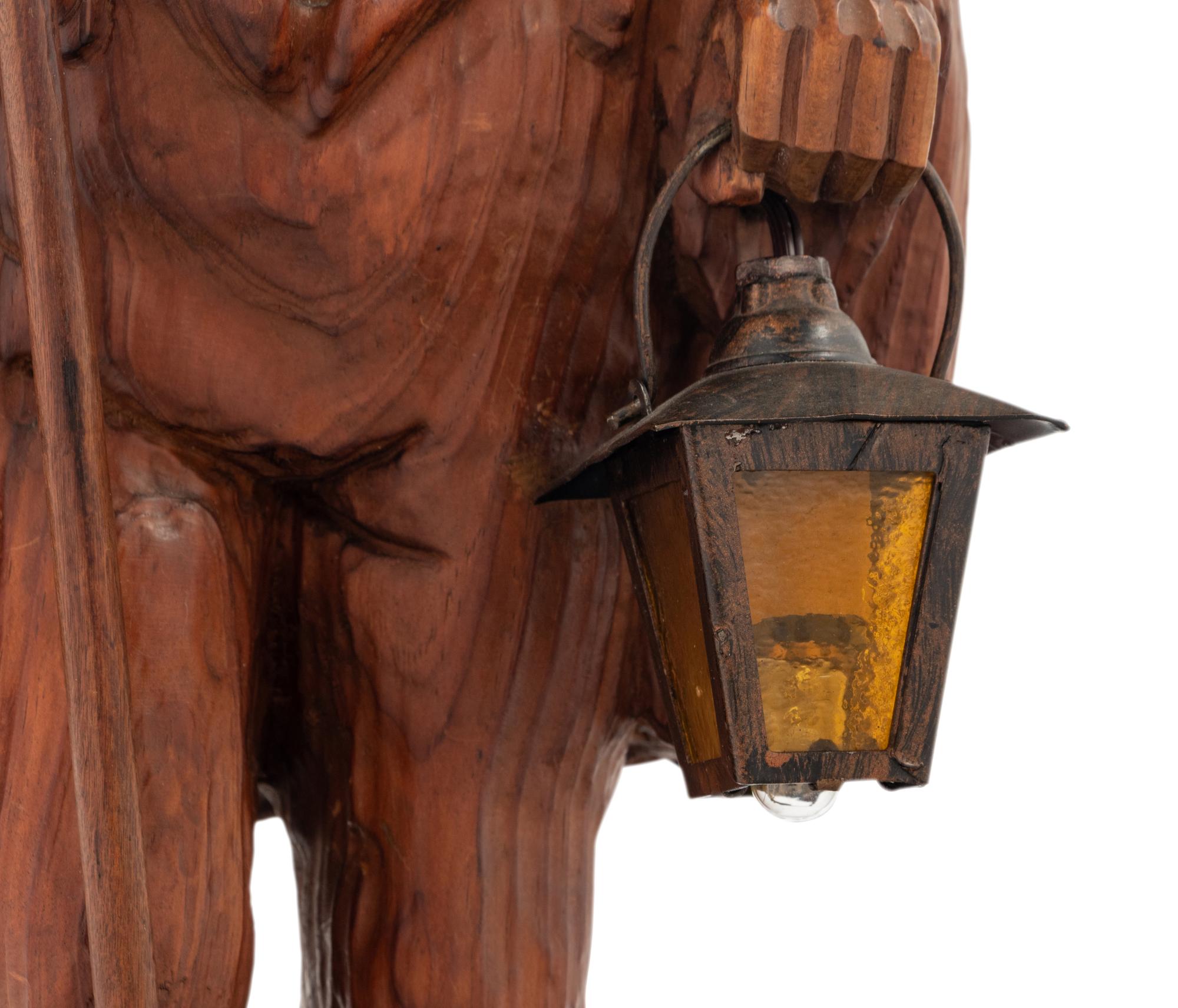 A Black Forest Carved Walnut 'Night Watchman' Lamp