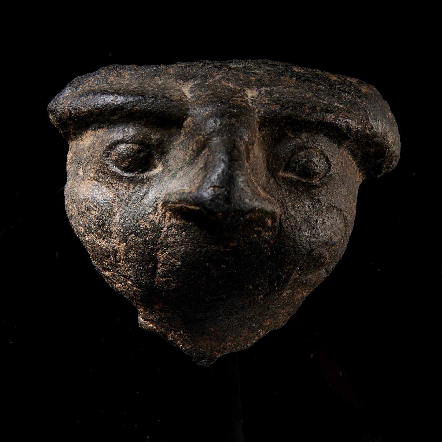 An Egyptian Basalt Falcon Face Fragment