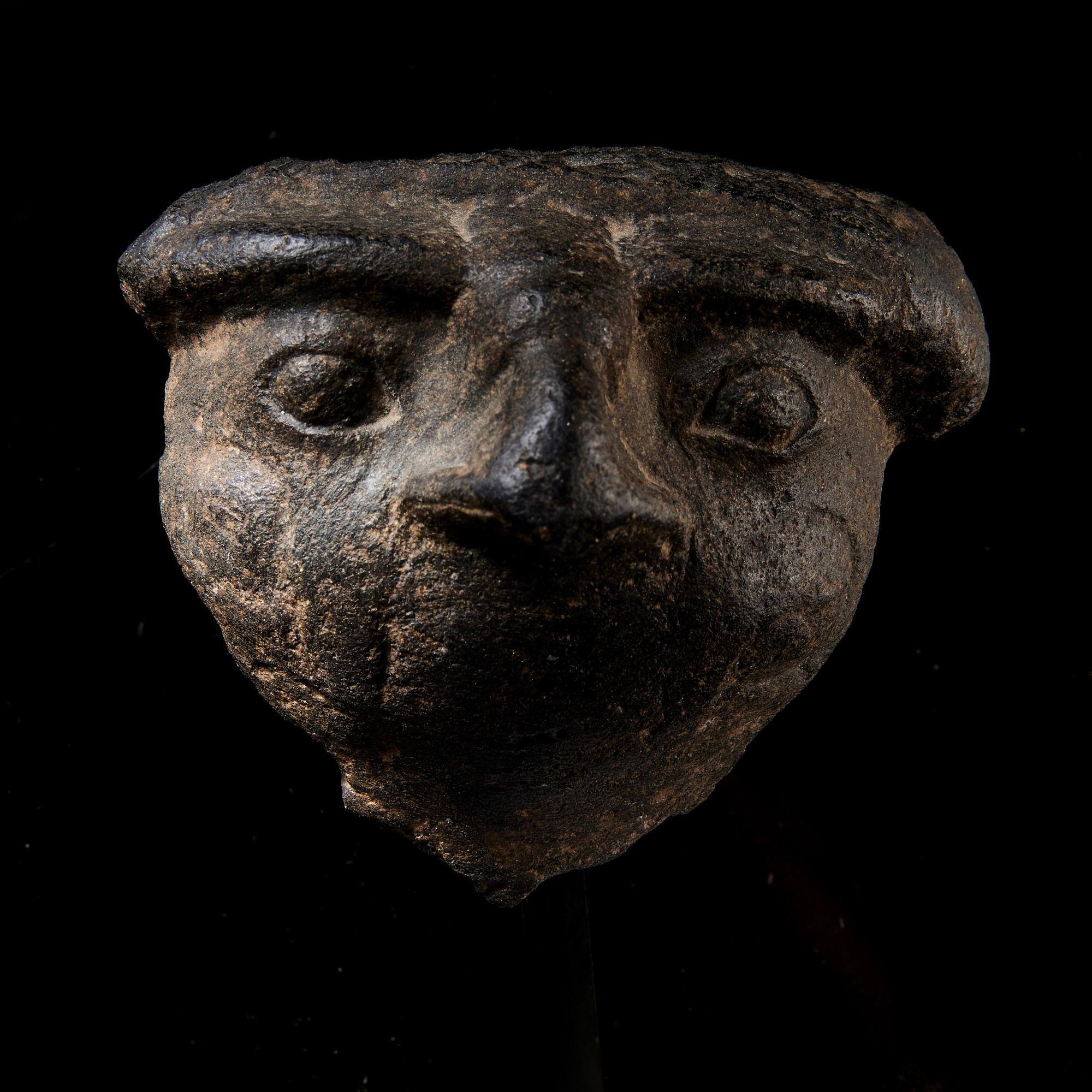 An Egyptian Basalt Falcon Face Fragment