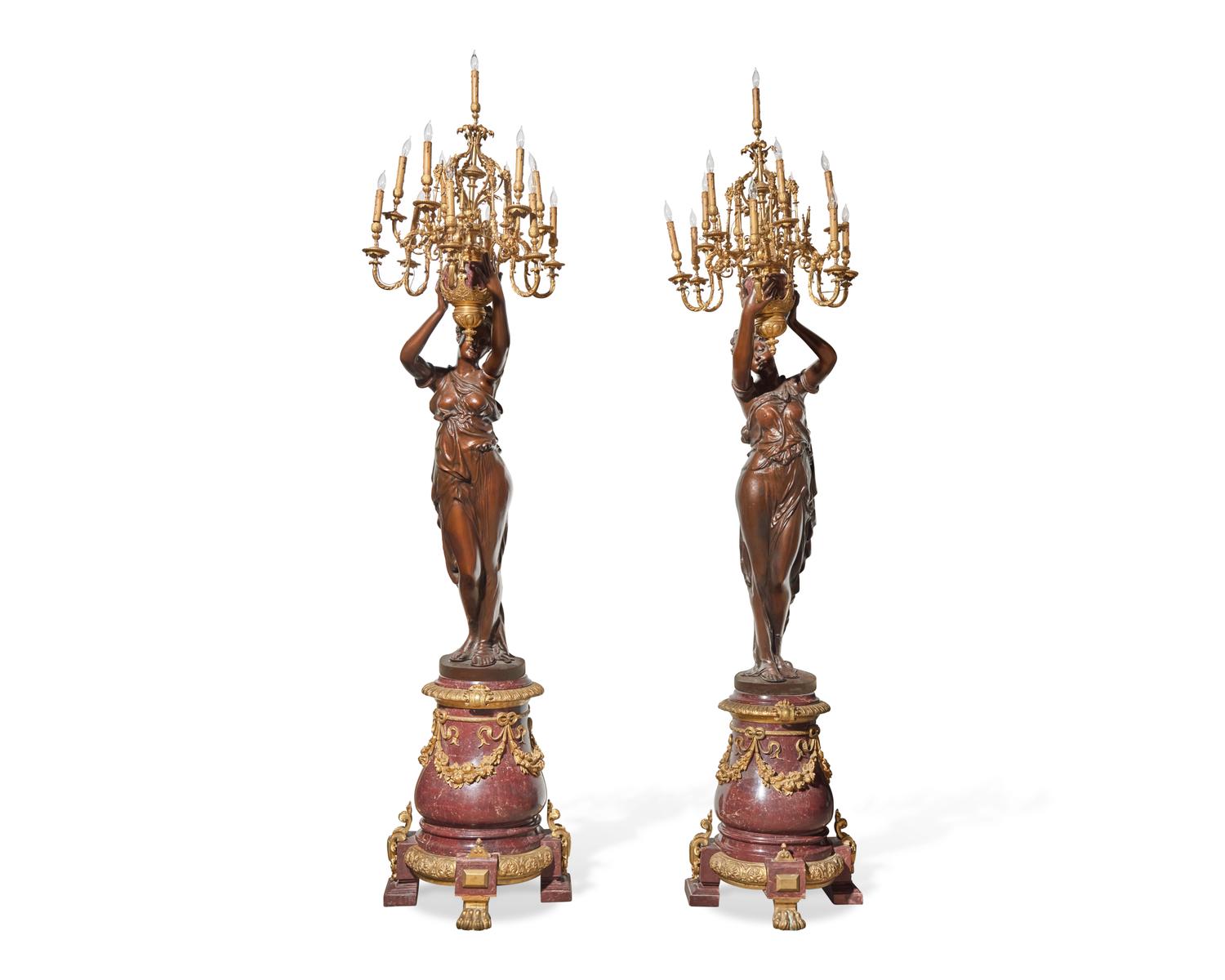 An impressive pair of large French gilt-bronze mounted bronze and rouge marble torchères, 20th century