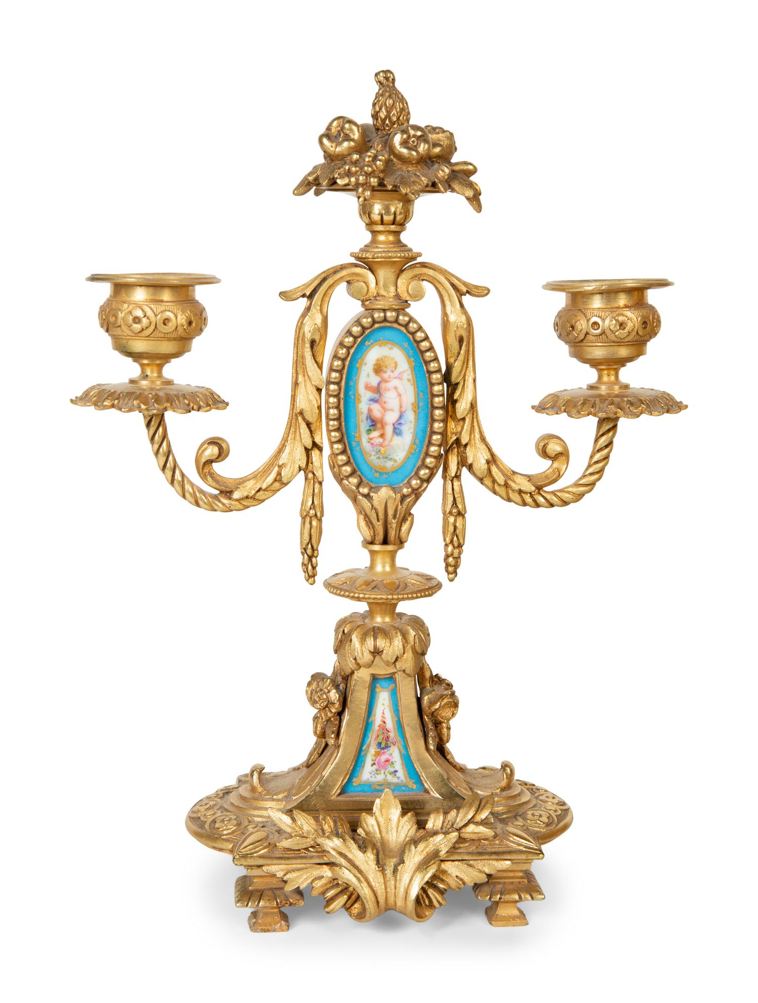 A French Gilt Bronze and Sèvres Porcelain Clock Garniture
