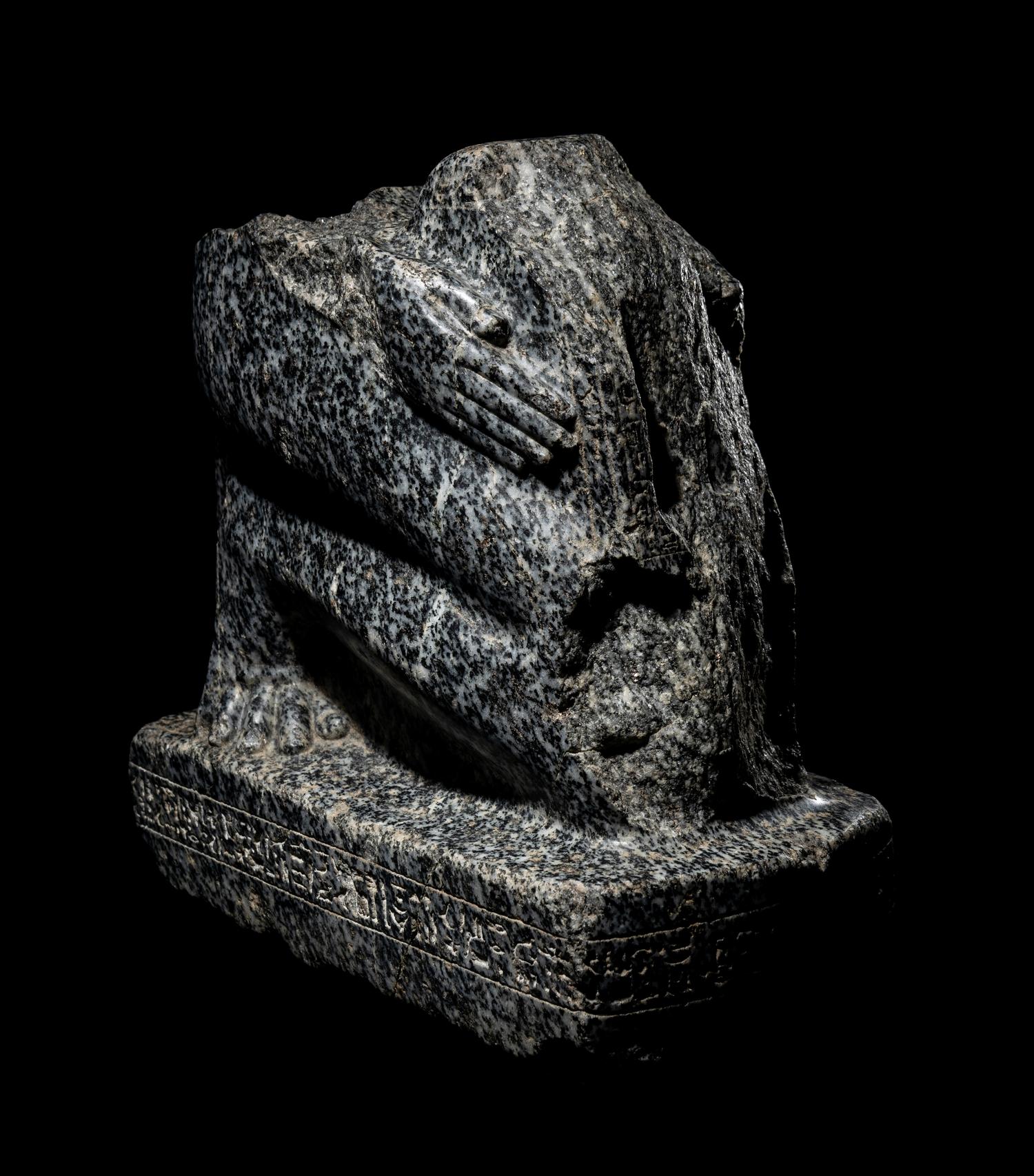 An Egyptian Gneiss Fragment of a Kneeling Figure