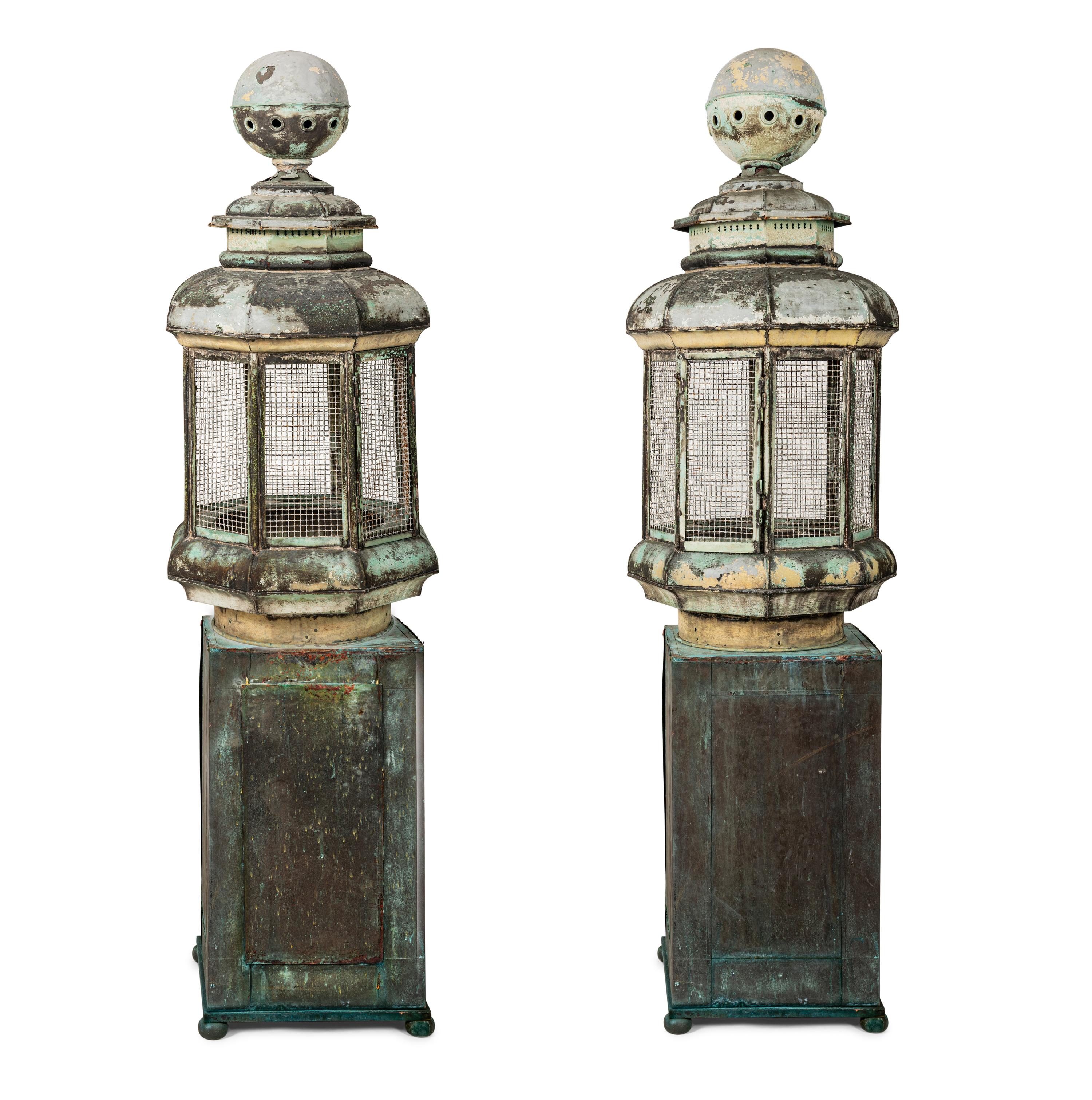 A Pair of Weathered Painted Sheet Metal Lanterns Converted to Bird Cages
