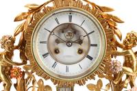 A Louis XV Style Red Cut Glass, Gilt Bronze and Porcelain Clock