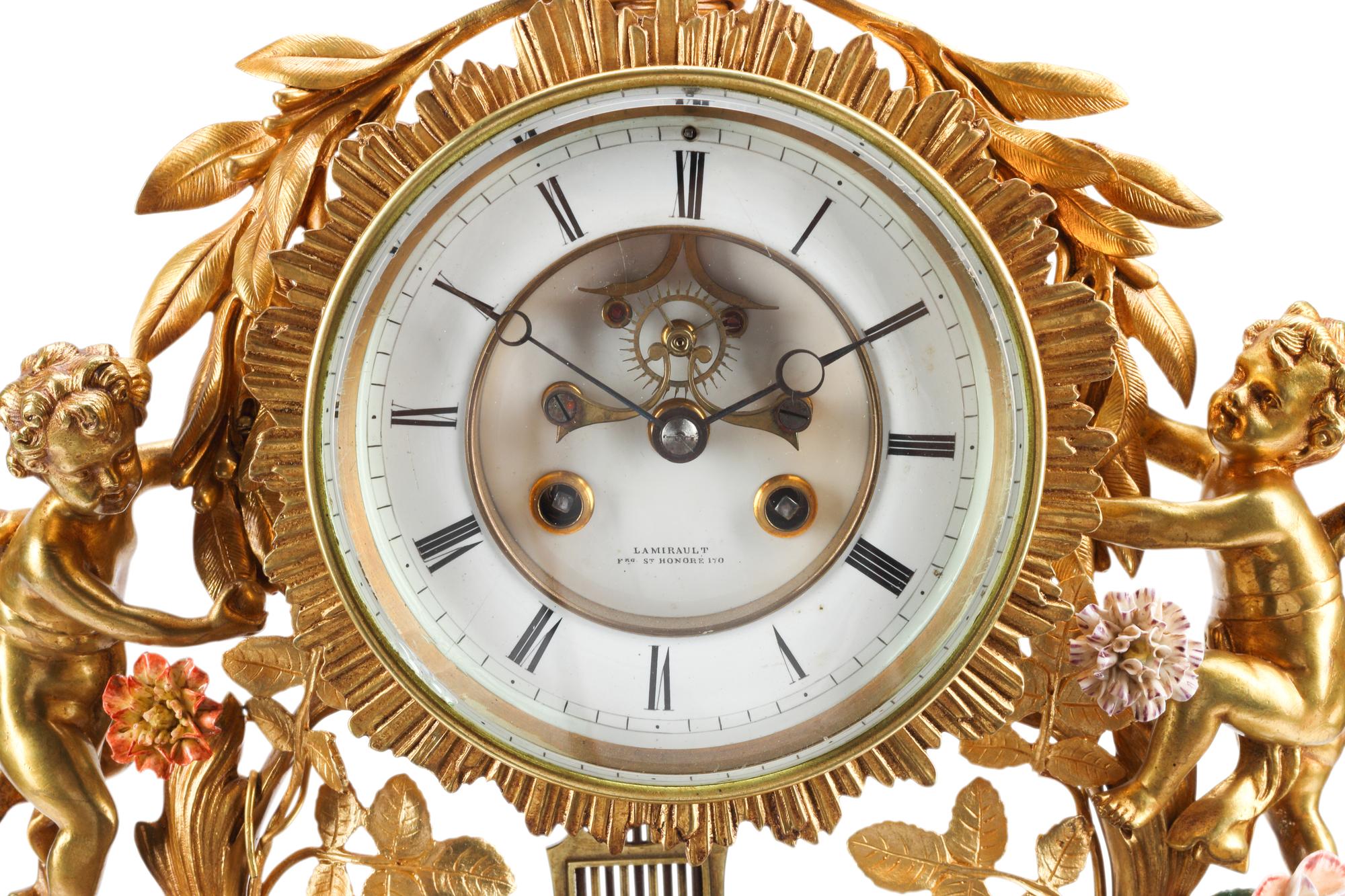 A Louis XV Style Red Cut Glass, Gilt Bronze and Porcelain Clock