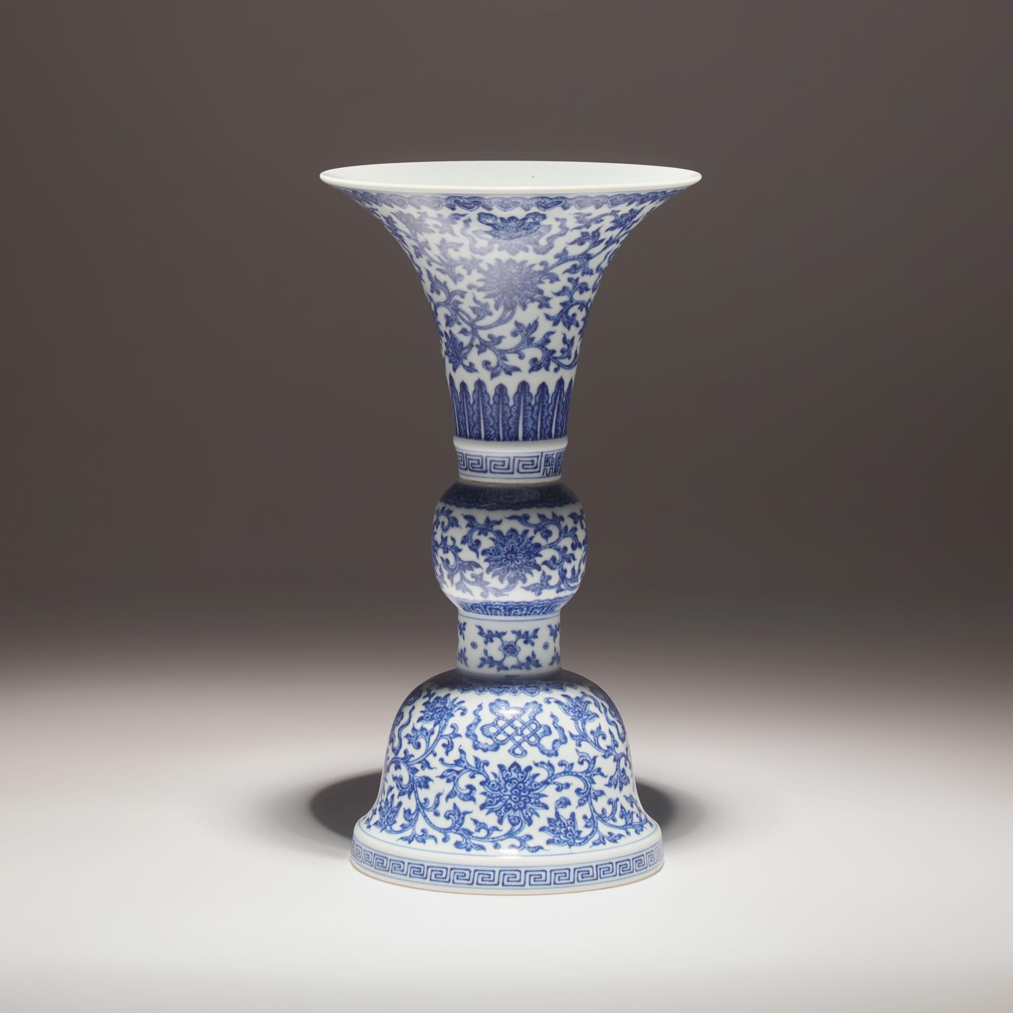 A Chinese Blue and White Porcelain Gu Vase, Jiaqing Mark and of the Period — 清嘉慶 青花纏枝蓮八吉祥花觚