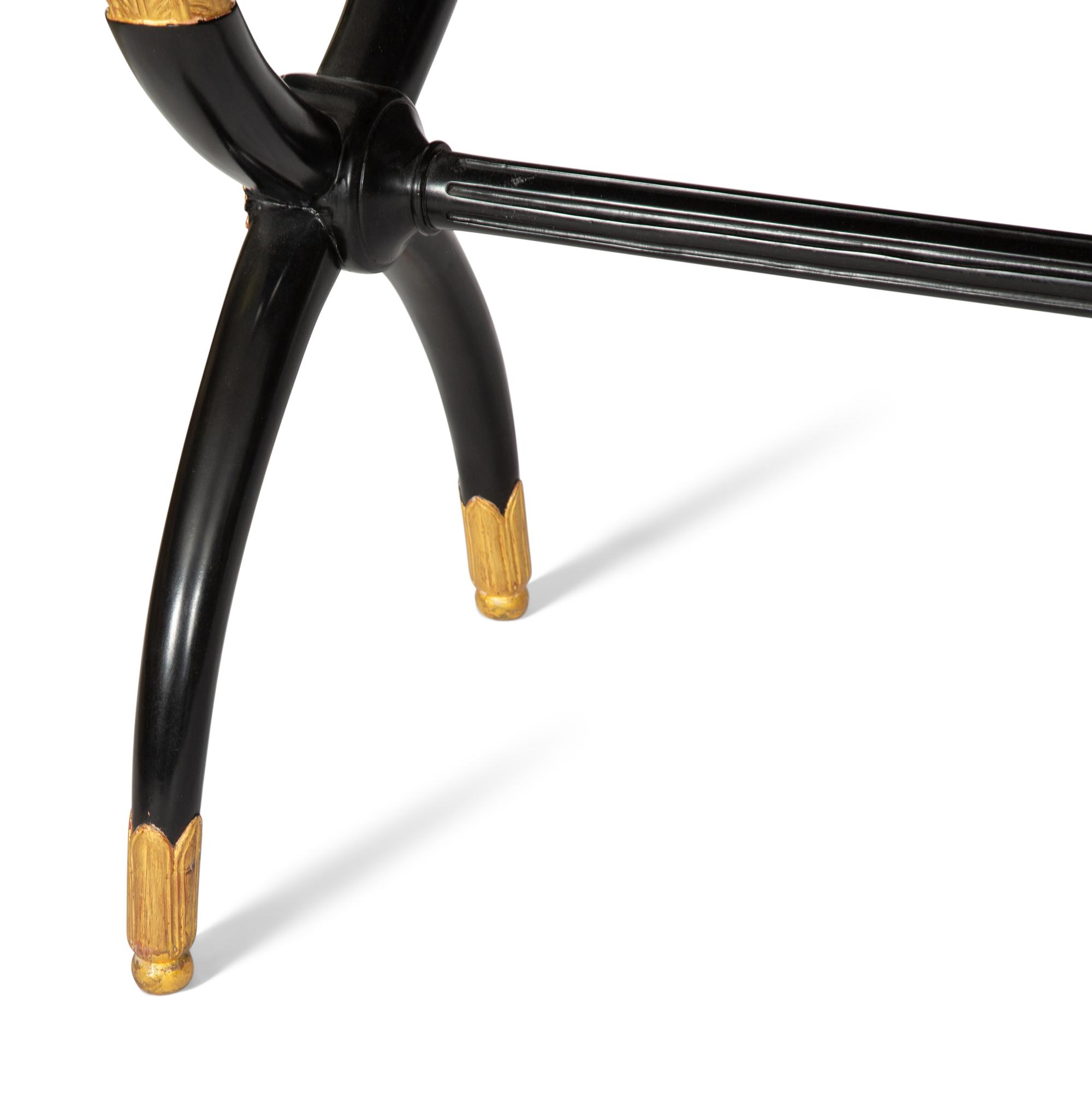 A Regency Style Parcel Gilt and Ebonized Mahogany Leather Top Console Table