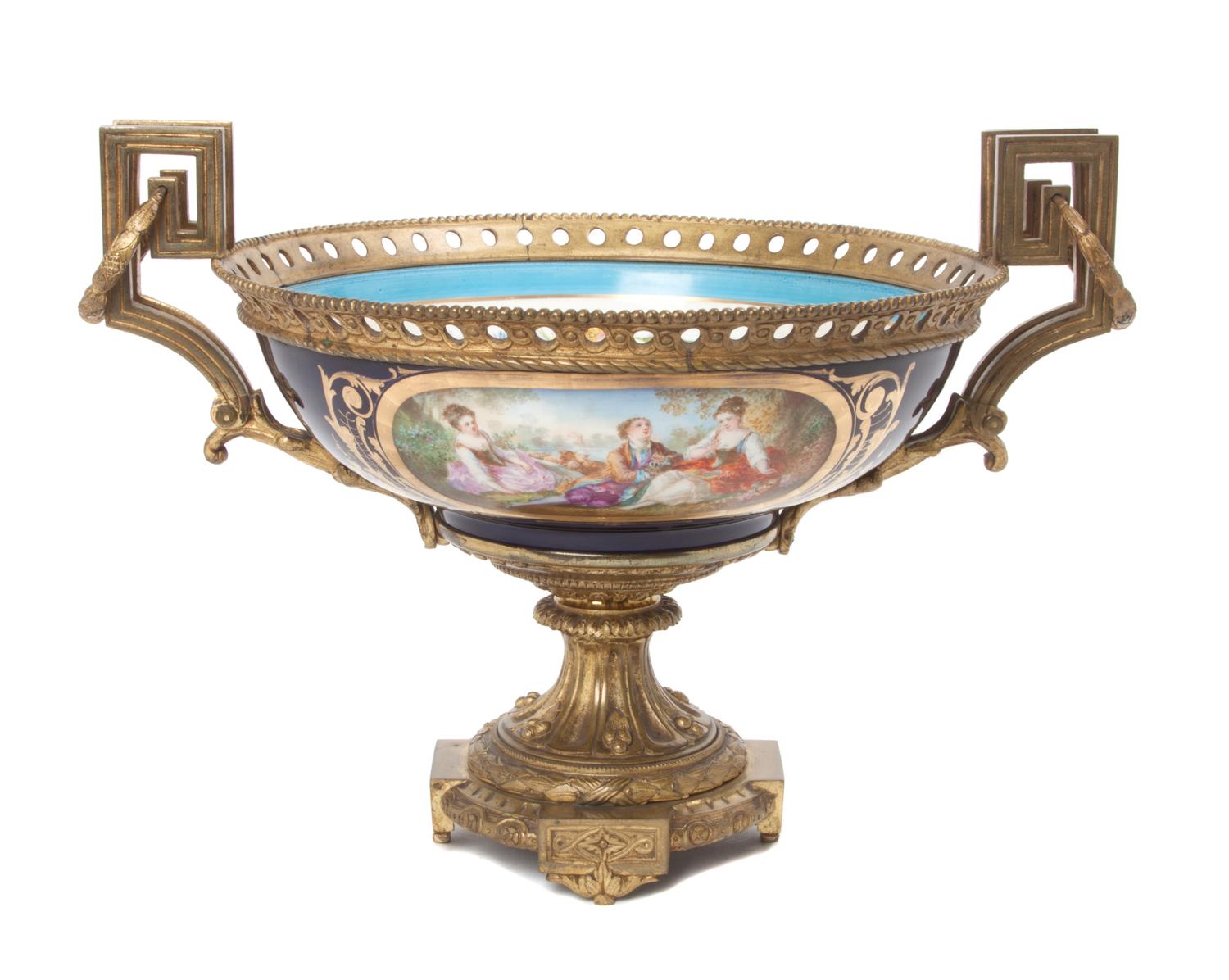 A Sevres Style Gilt Bronze Mounted Porcelain Center Bowl Height 9 1/2 x diameter 16 1/2 inches.