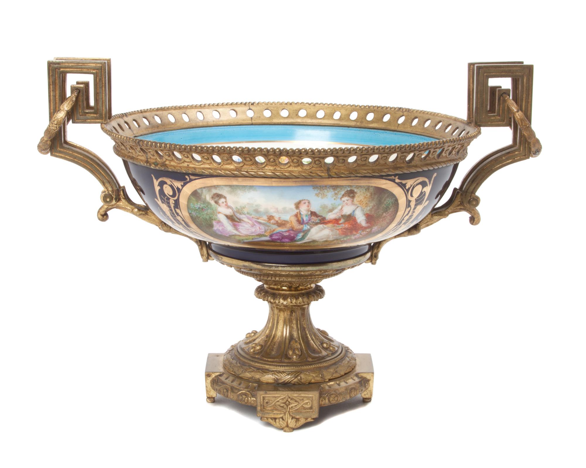 A Sevres Style Gilt Bronze Mounted Porcelain Center Bowl Height 9 1/2 x diameter 16 1/2 inches.