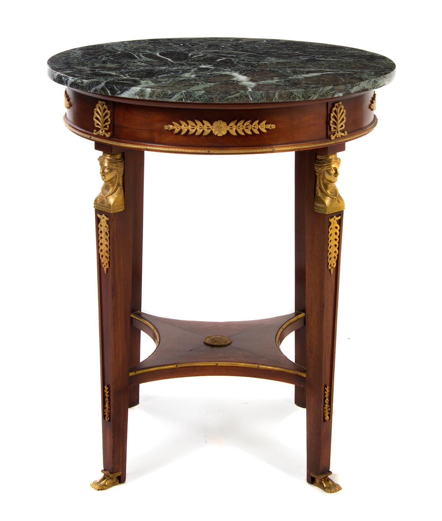 An Empire Style Gilt Metal Mounted Mahogany Gueridon, Height 30 1/8 x diameter 27 inches.