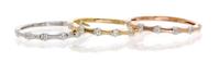 A Collection of 18 Karat Tricolor Gold and Diamond Stacking Rings, 3.20 dwts.