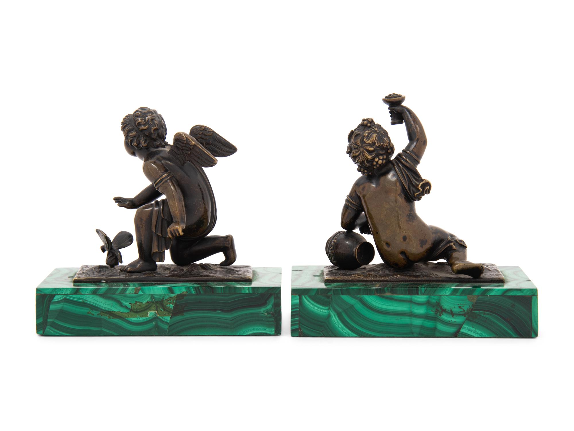 A Pair of Bronze Figures of Kneeling Putti