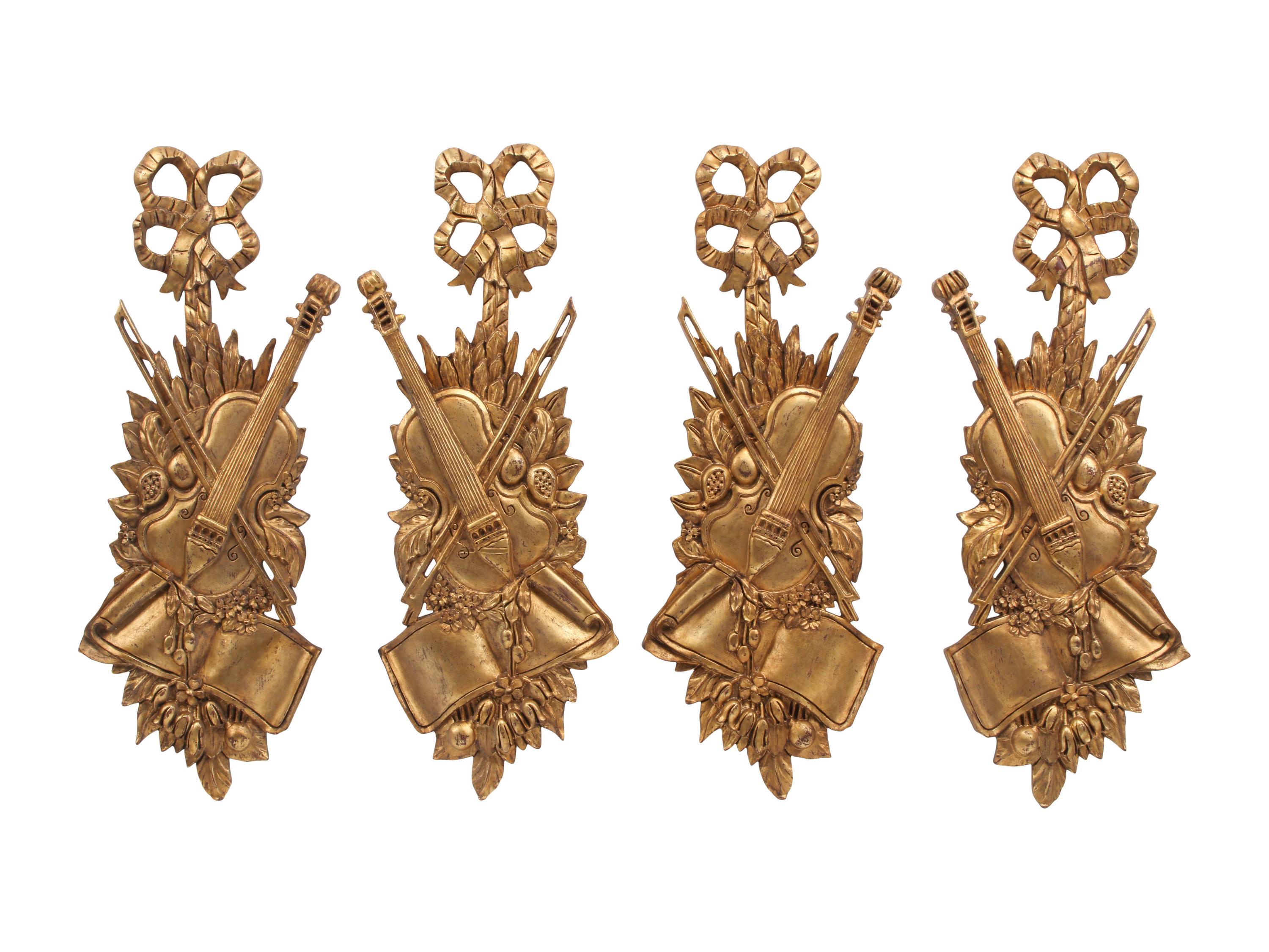 A Set of Four Giltwood Wall Trophies