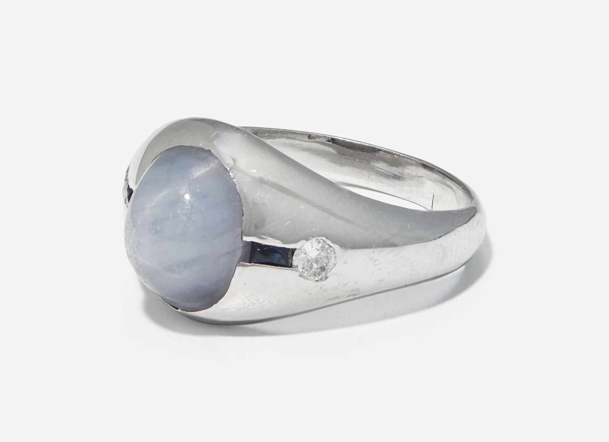 A 20K White Gold, Star Sapphire, and Diamond Ring