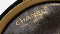 A Chanel Black Silk Embroidered Rhinestone Circular Clutch, 7" diameter.