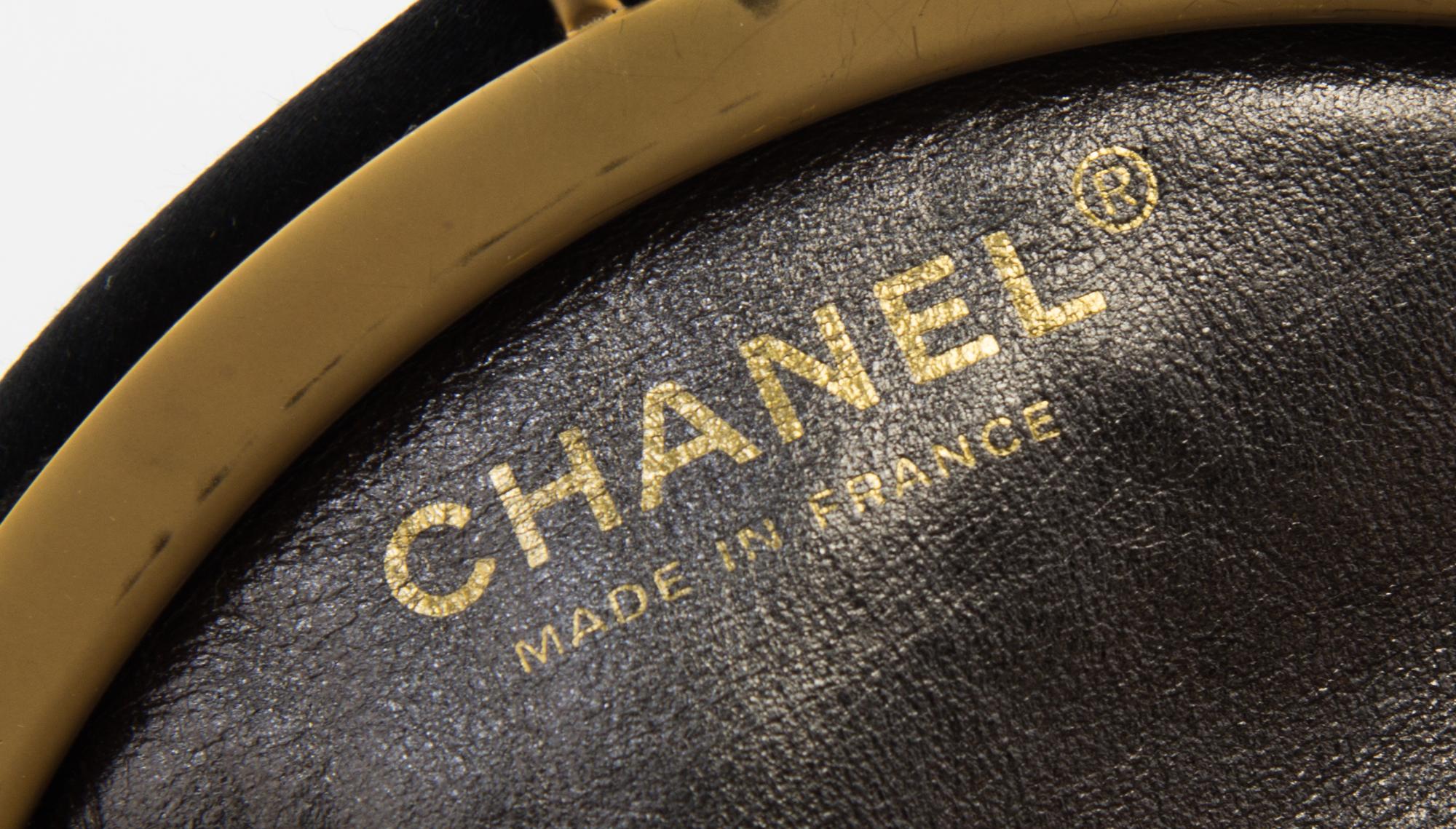 A Chanel Black Silk Embroidered Rhinestone Circular Clutch, 7" diameter.