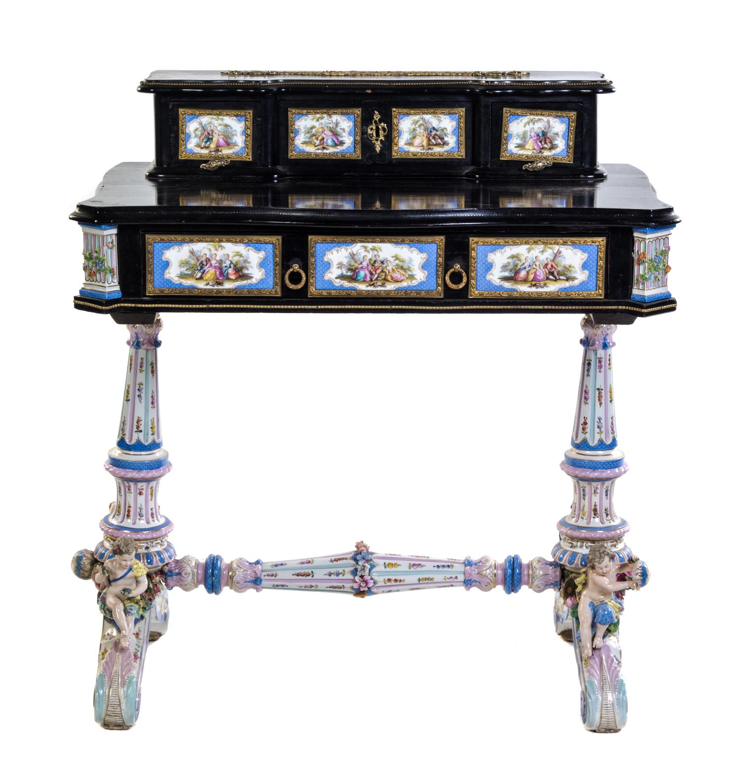 A German Gilt Metal and Porcelain Mounted Ebonized Writing Table Height 36 3/4 x width 34 x depth 20 inches.