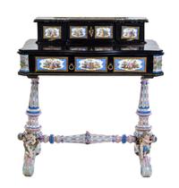 A German Gilt Metal and Porcelain Mounted Ebonized Writing Table Height 36 3/4 x width 34 x depth 20 inches.