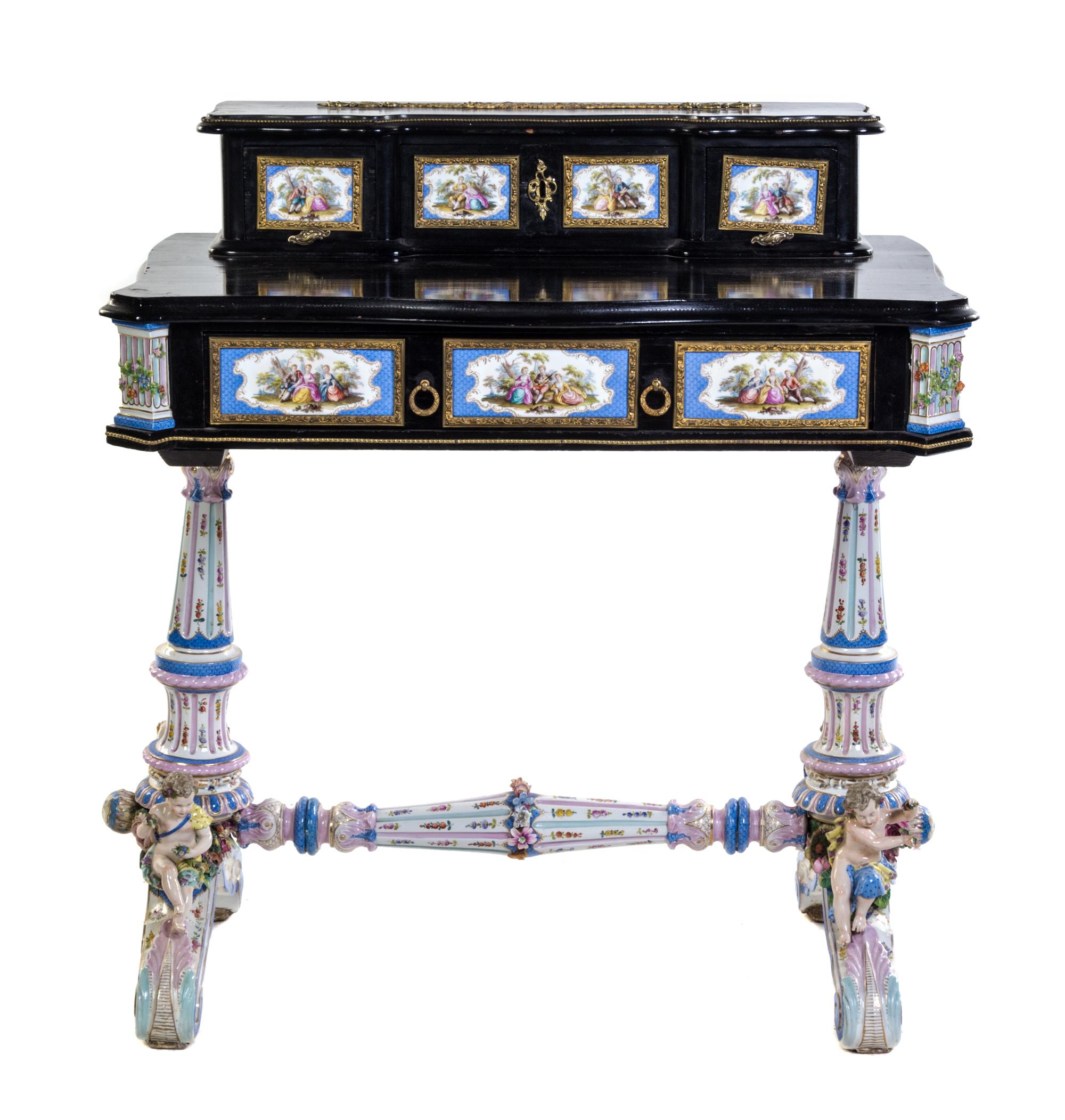 A German Gilt Metal and Porcelain Mounted Ebonized Writing Table Height 36 3/4 x width 34 x depth 20 inches.