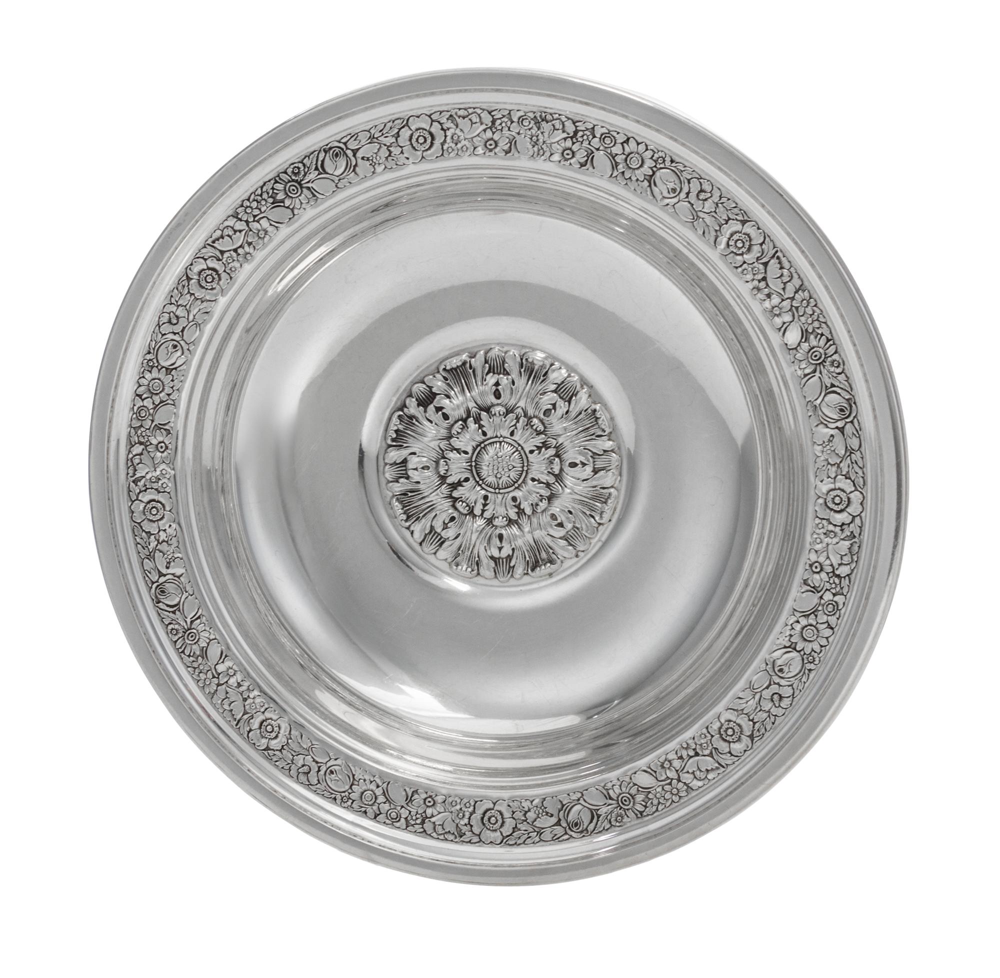 An American Silver Bowl, Reed & Barton, Taunton, MA., 1937, circular, the border chased with dense flowers and foliage, center with a l