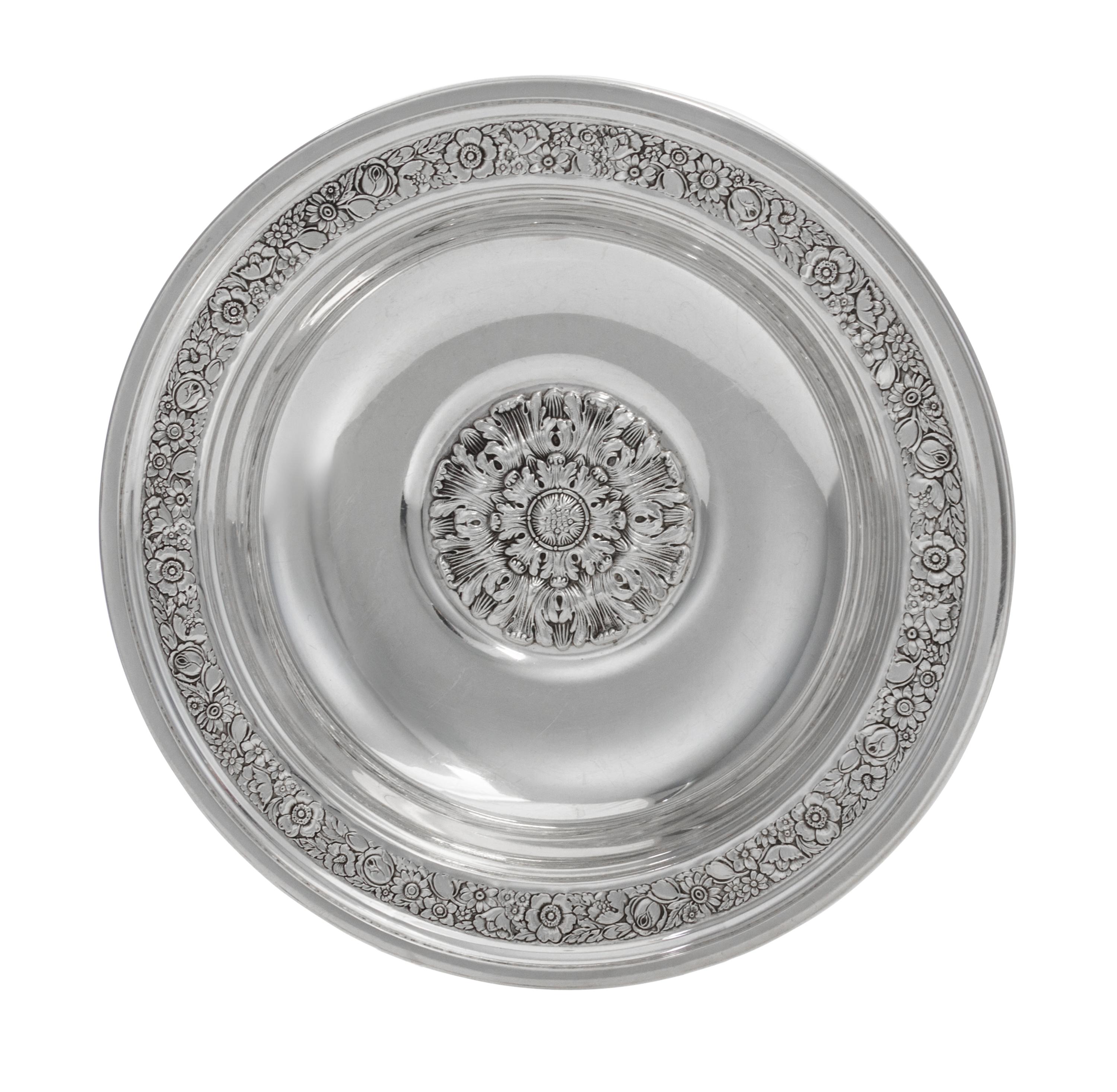 An American Silver Bowl, Reed & Barton, Taunton, MA., 1937, circular, the border chased with dense flowers and foliage, center with a l