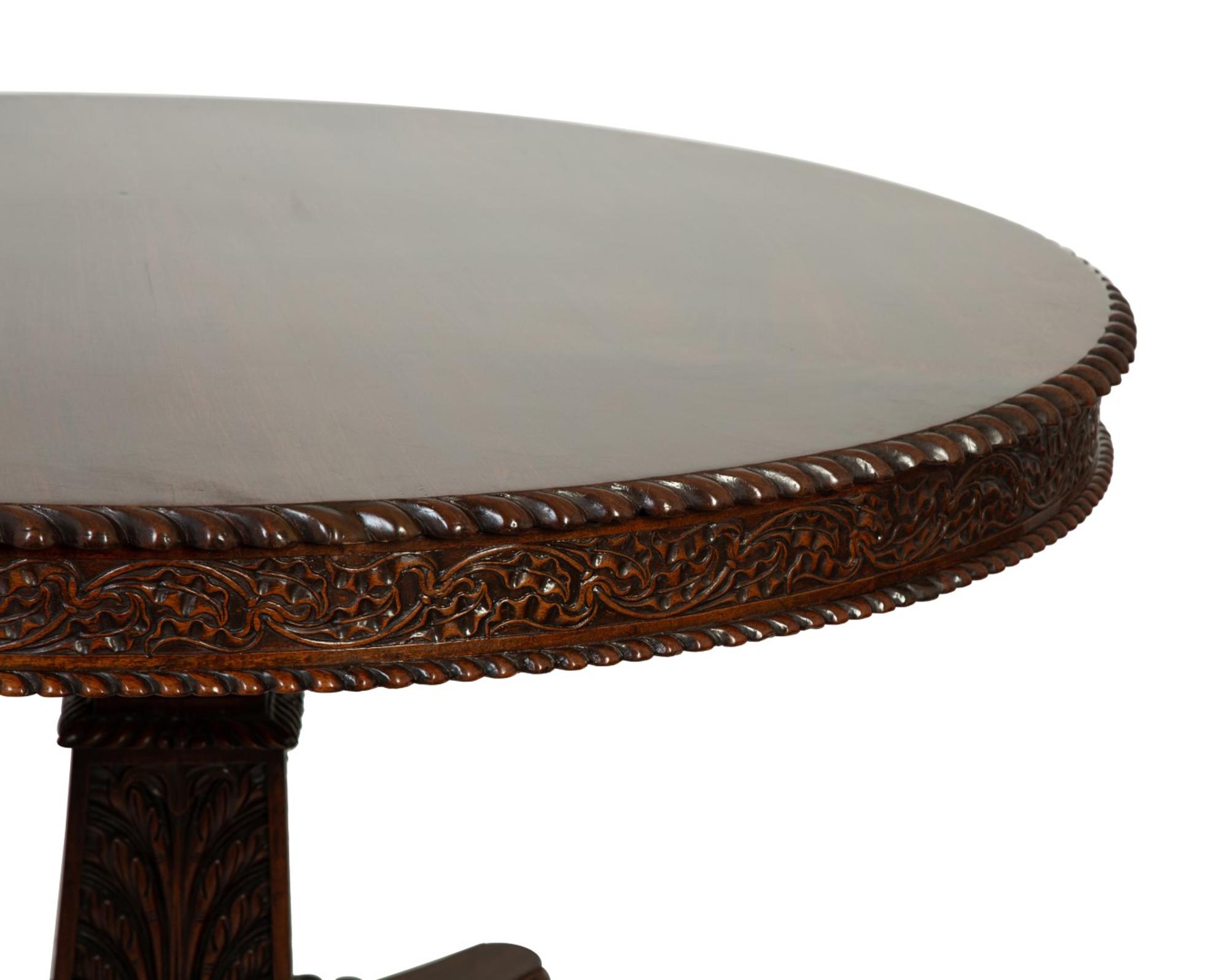 An Anglo-Indian Carved Padouk Wood Tilt Top Center Table — 19TH CENTURY