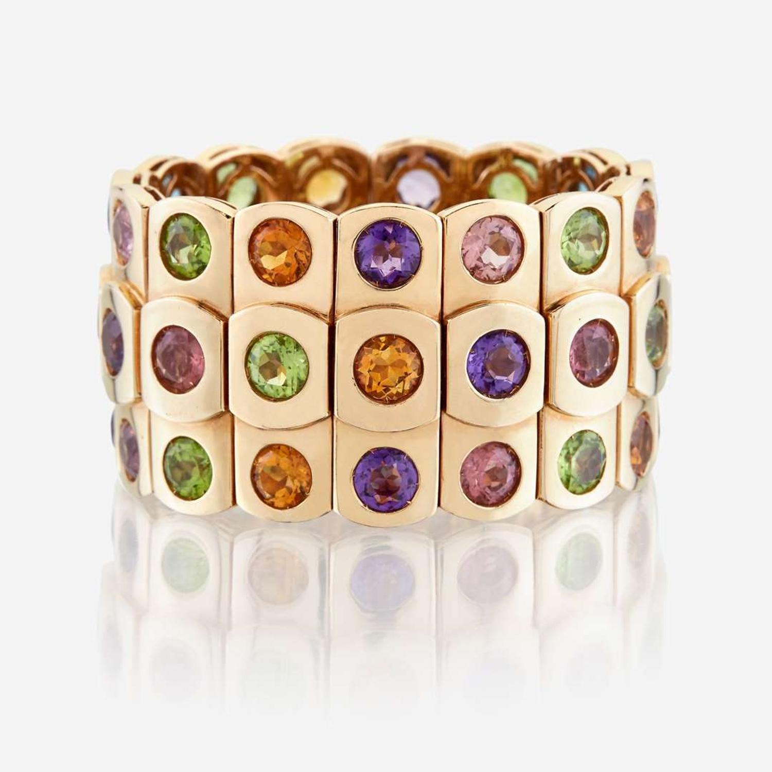 An eighteen karat gold and gem-set bangle