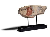 An Egyptian Painted Limestone Relief Fragment