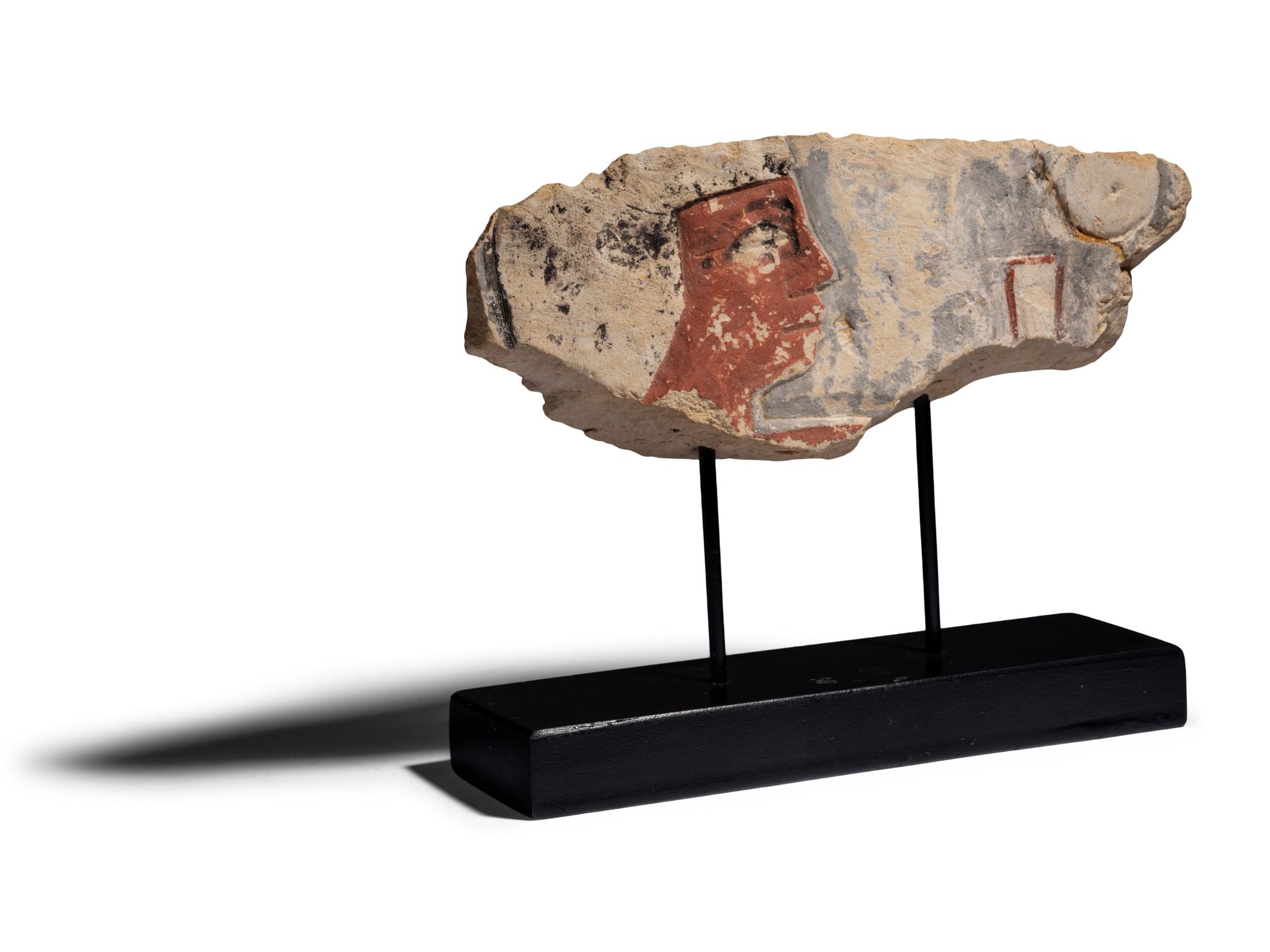 An Egyptian Painted Limestone Relief Fragment