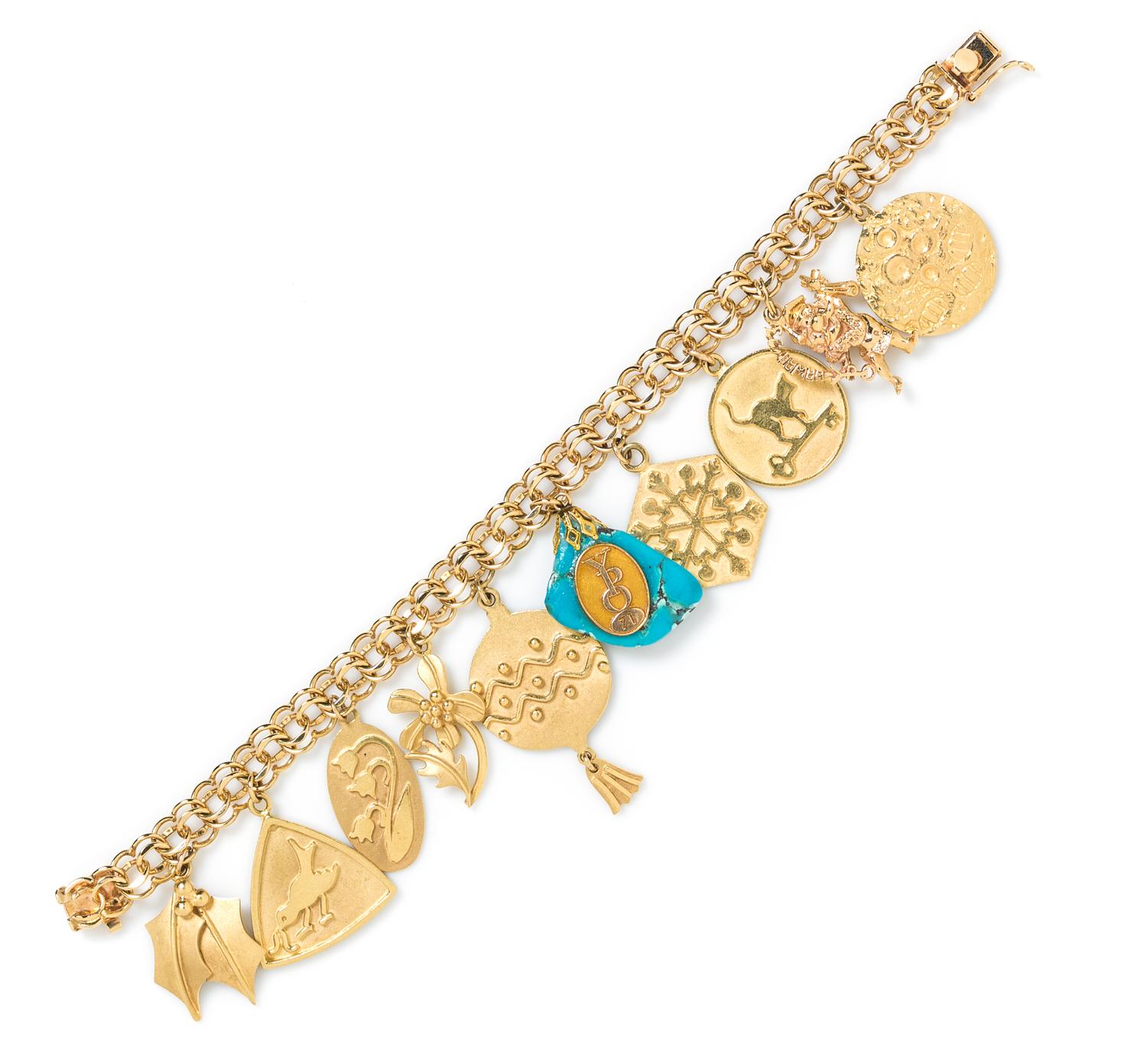 A 14 Karat Yellow Gold Charm Bracelet with 13 Attached and Unattached Gold and Gold Tone Charms, 48.40 dwts.