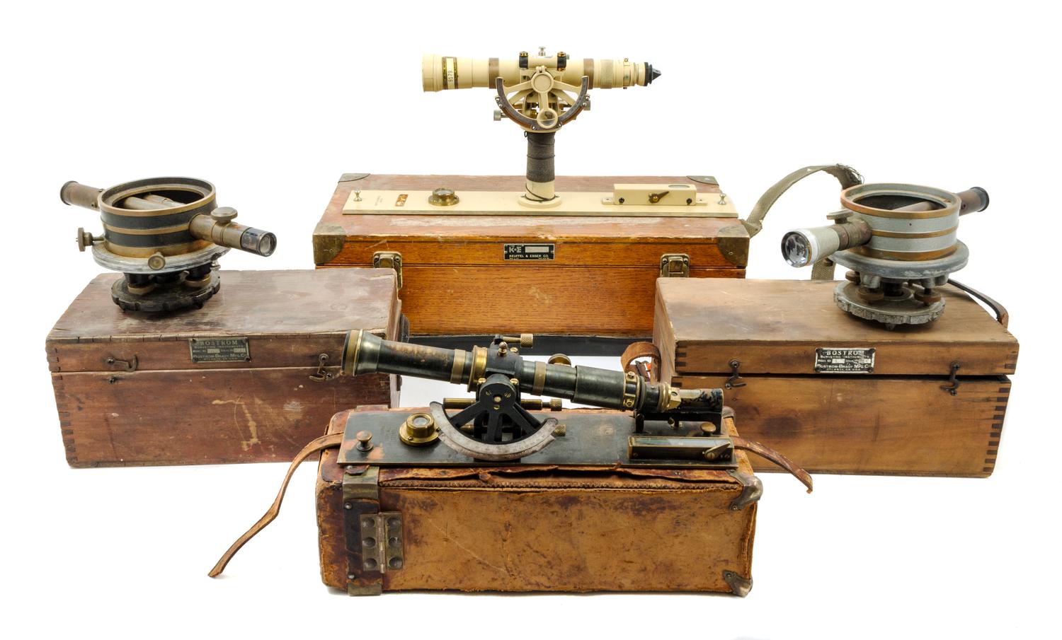 A Group of Four Cased Surveyor's Levels Length of longest scope 11 inches.