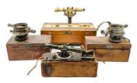 A Group of Four Cased Surveyor's Levels Length of longest scope 11 inches.