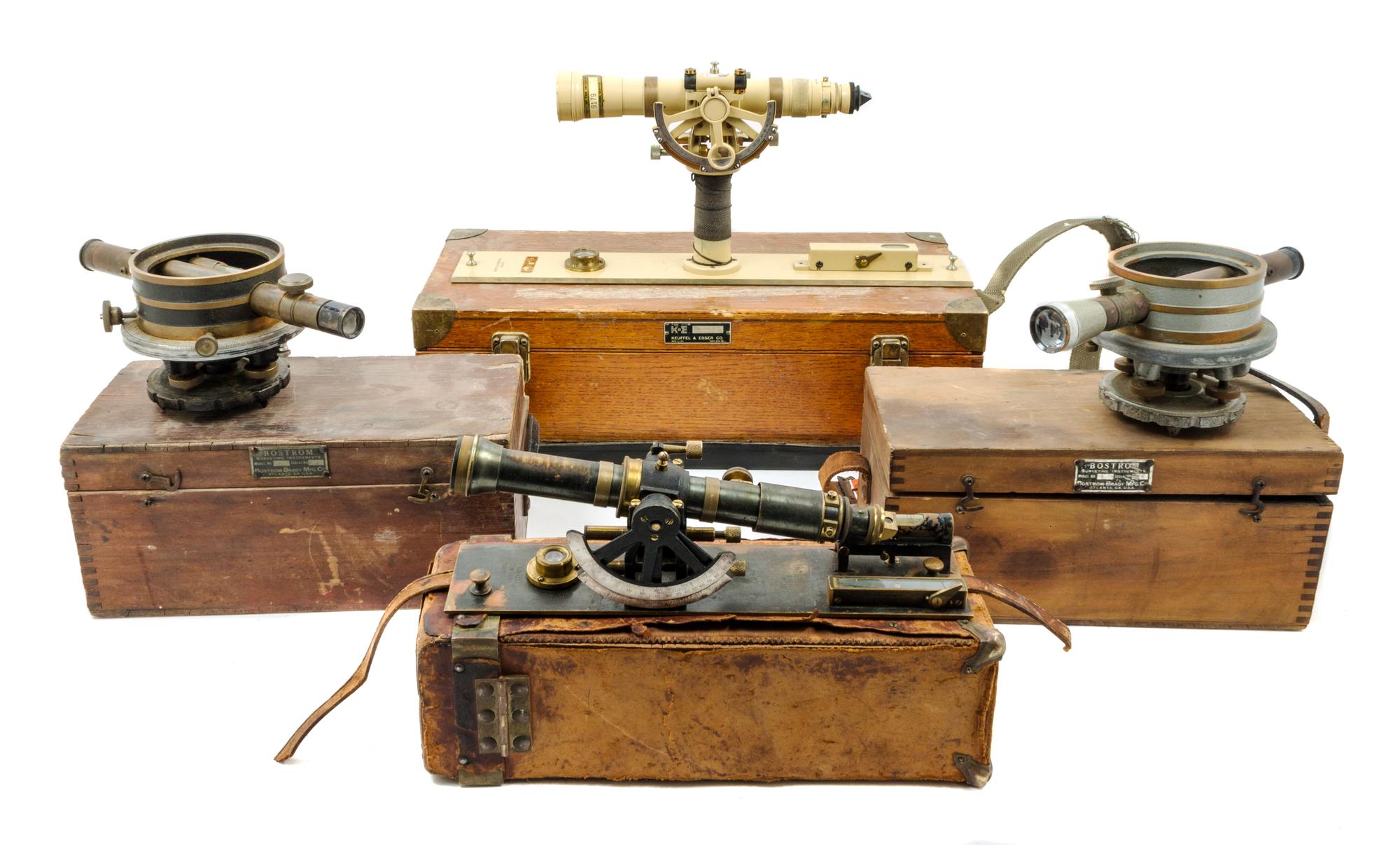 A Group of Four Cased Surveyor's Levels Length of longest scope 11 inches.