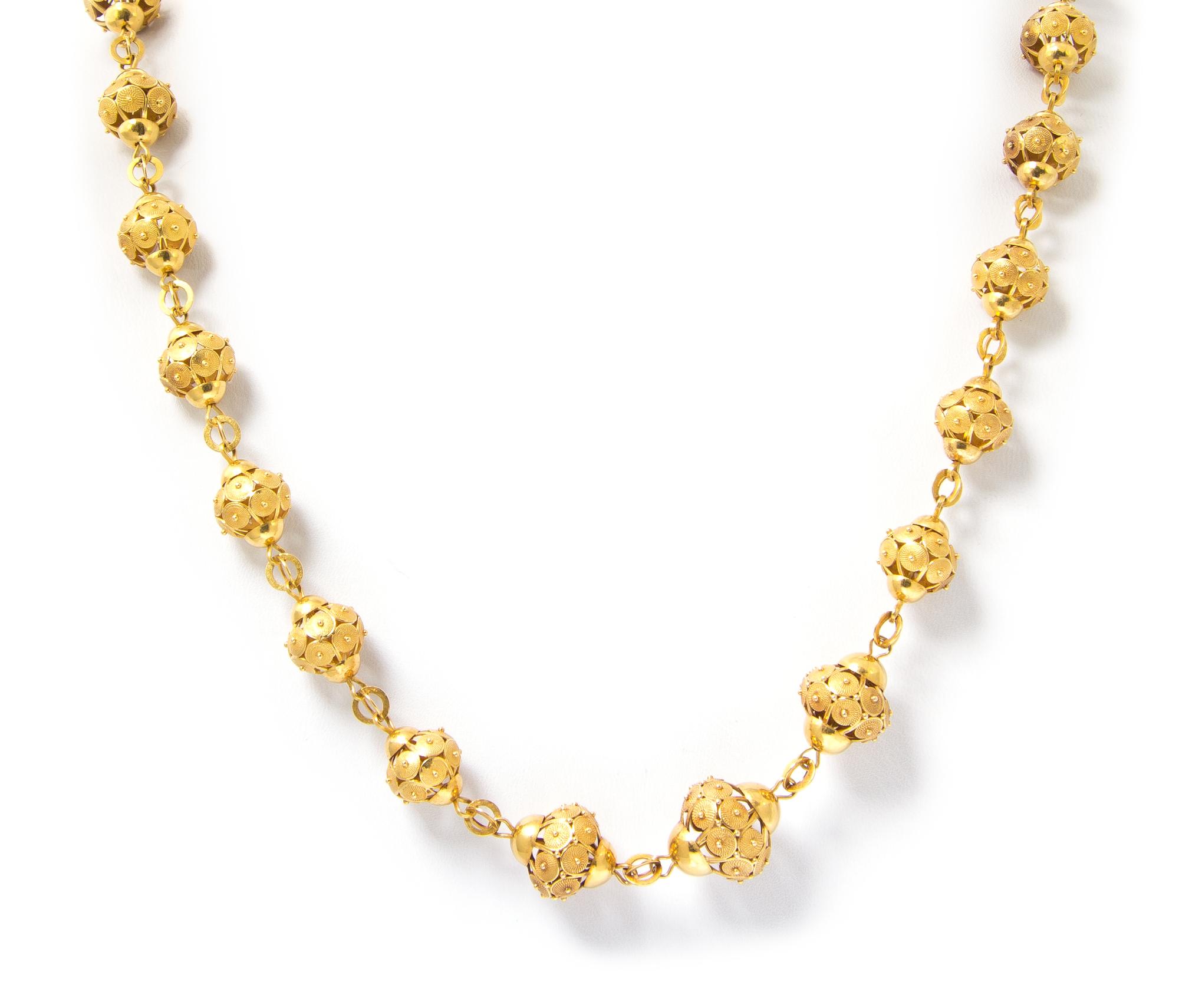 A Yellow Gold Graduated Textured Bead Longchain, 34.60 dwts.