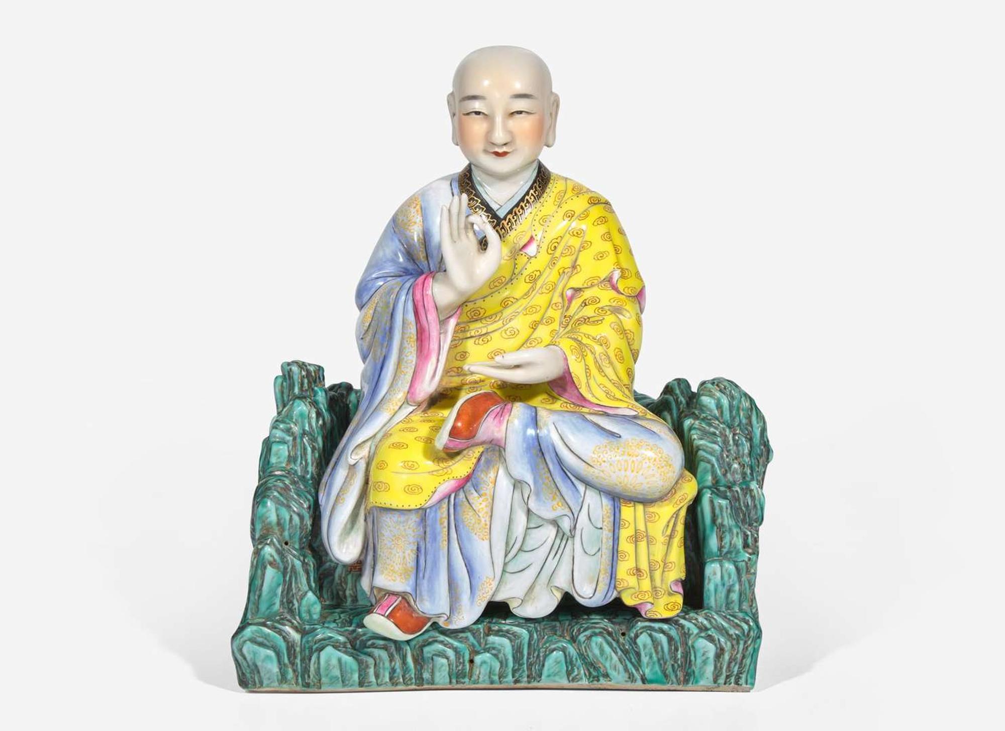 A Chinese famille rose-decorated porcelain figure of a seated lohan 粉彩羅漢坐像