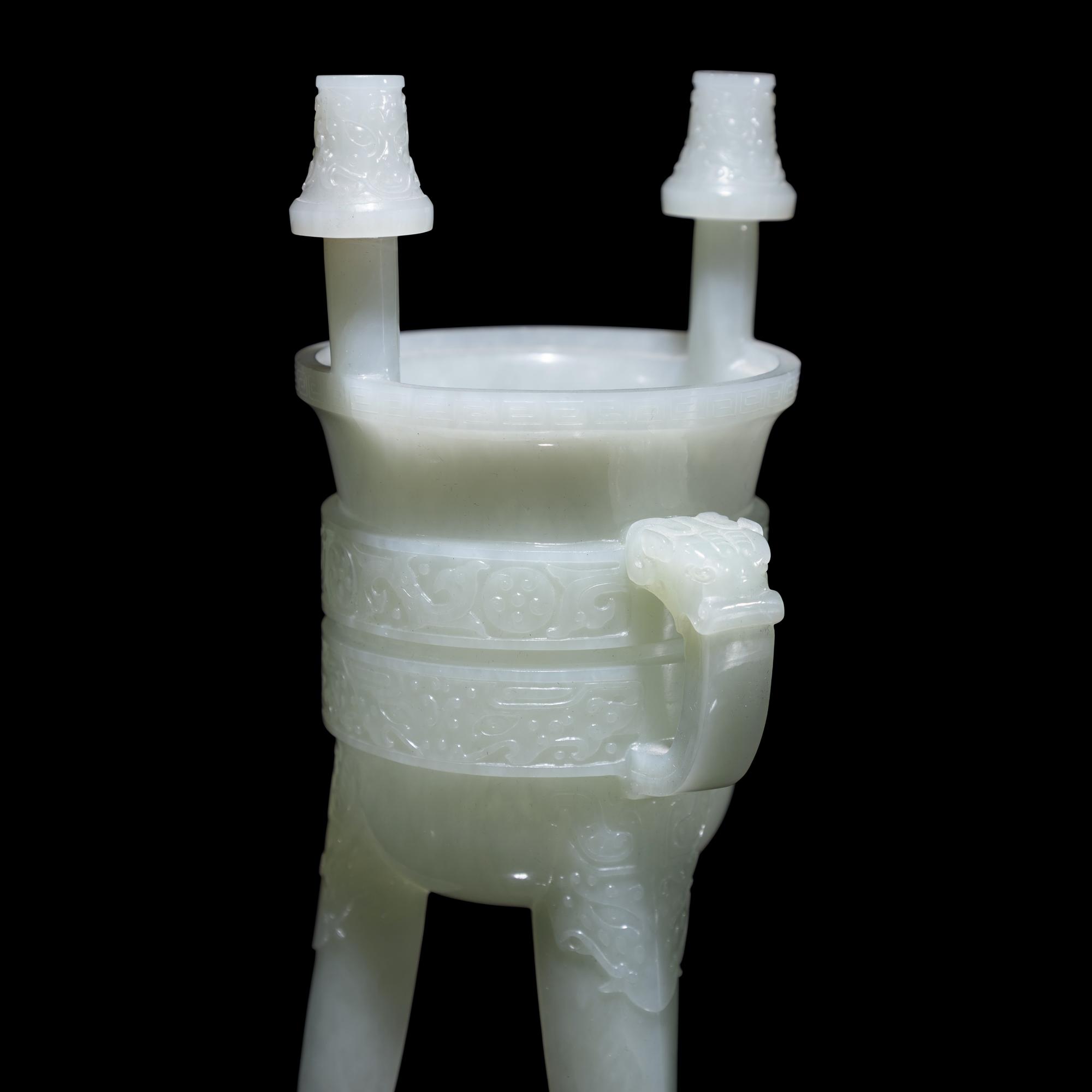 A Chinese Carved Pale Celadon Jade Tripod Vessel, Jia, Late Qing - Early Republic Period 晚清/民國 青白玉仿古斝