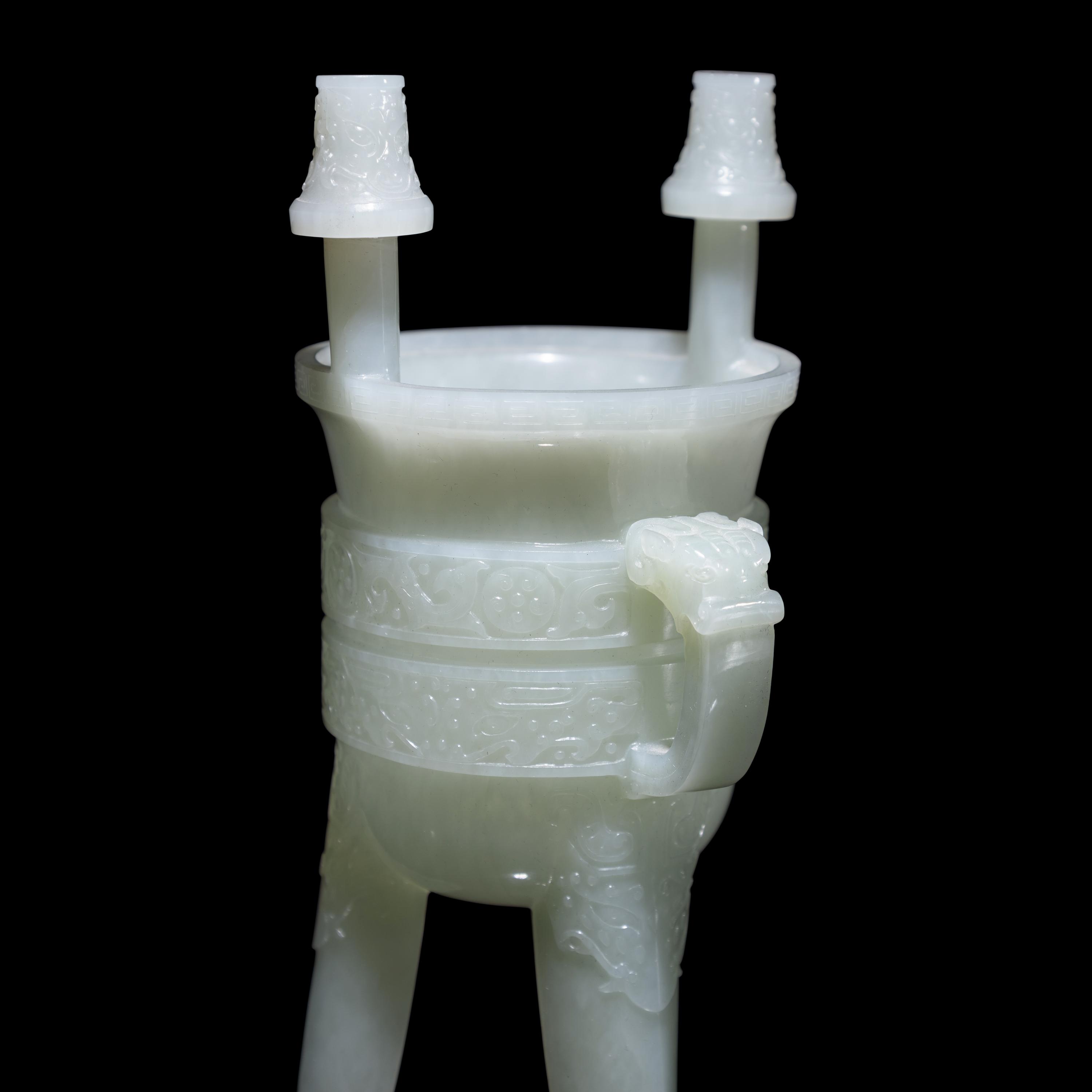 A Chinese Carved Pale Celadon Jade Tripod Vessel, Jia, Late Qing - Early Republic Period 晚清/民國 青白玉仿古斝
