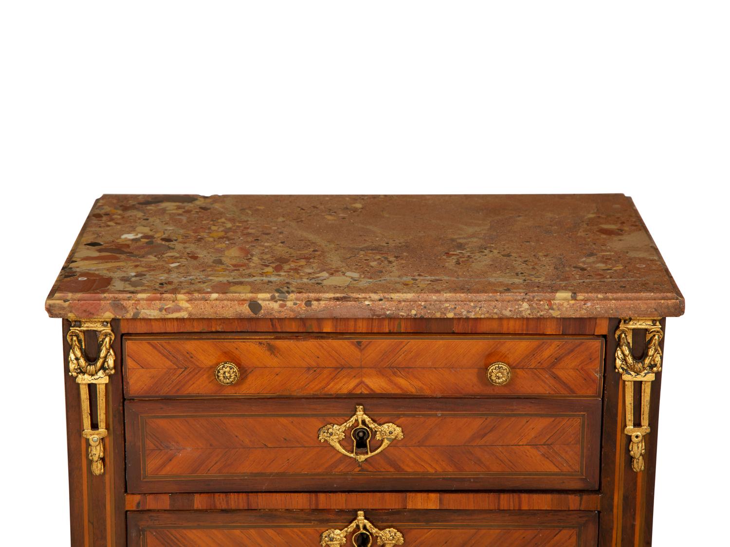 A Louis XVI Diminutive Marble-Top Four Drawer Chiffonier