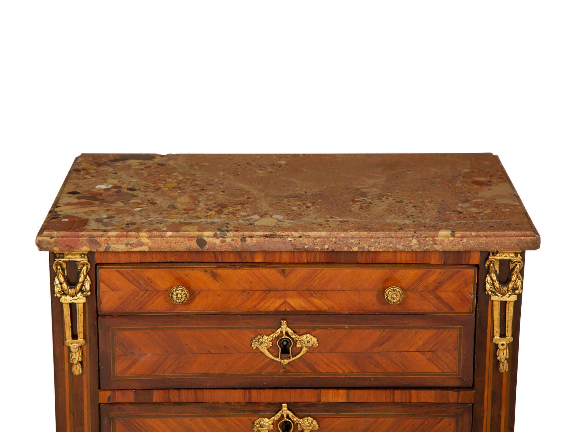 A Louis XVI Diminutive Marble-Top Four Drawer Chiffonier