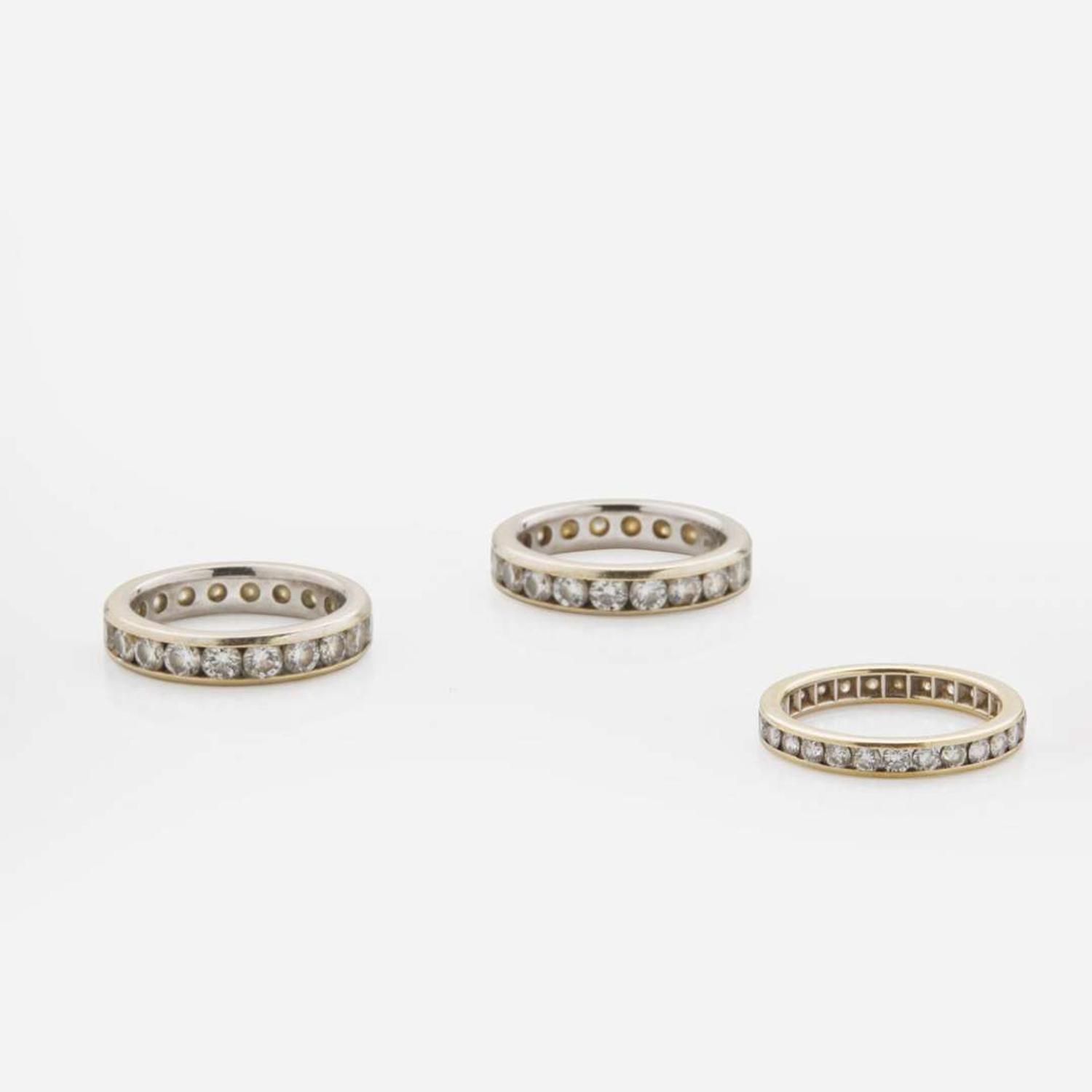 A Collection of Three 18K Gold and Diamond Bands