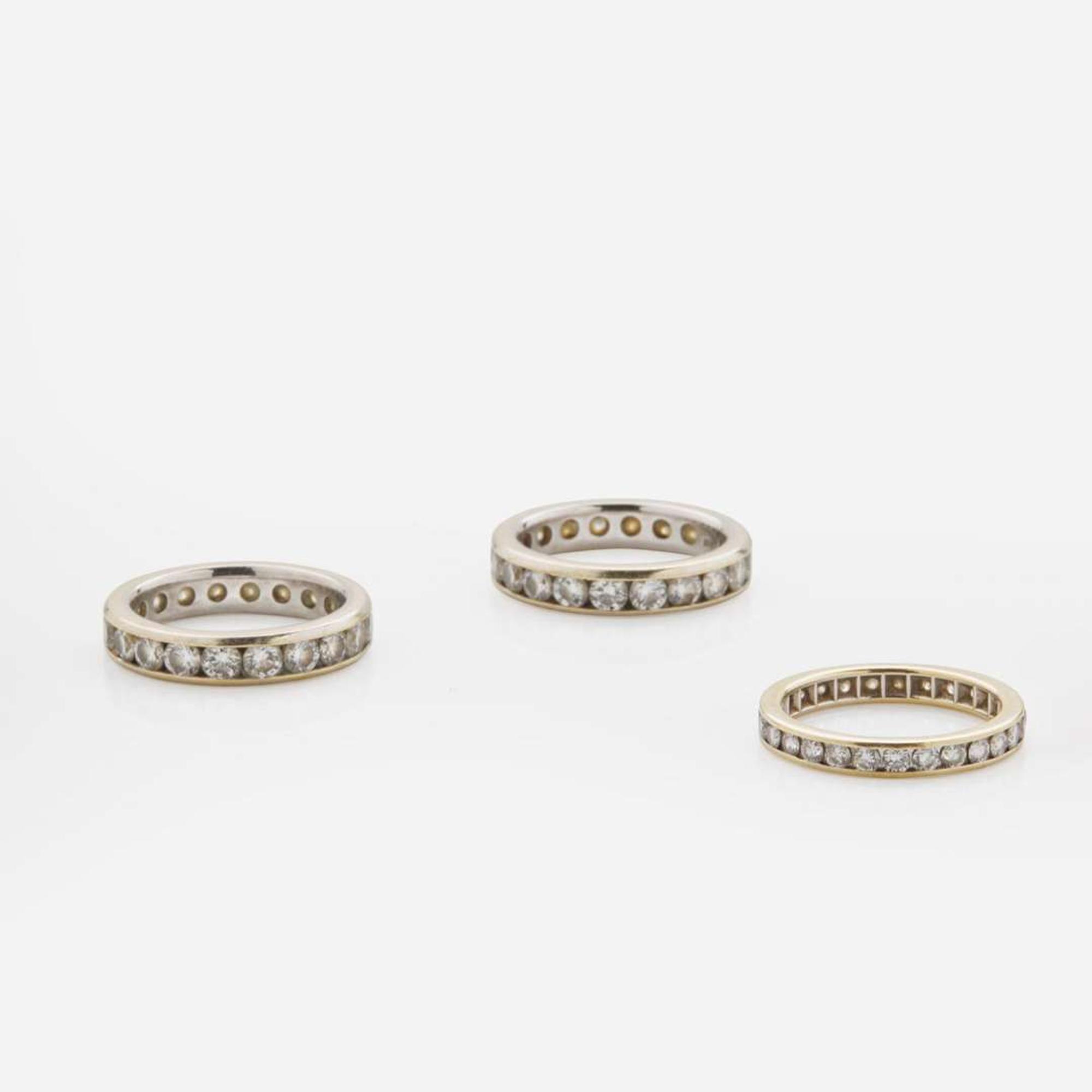 A Collection of Three 18K Gold and Diamond Bands