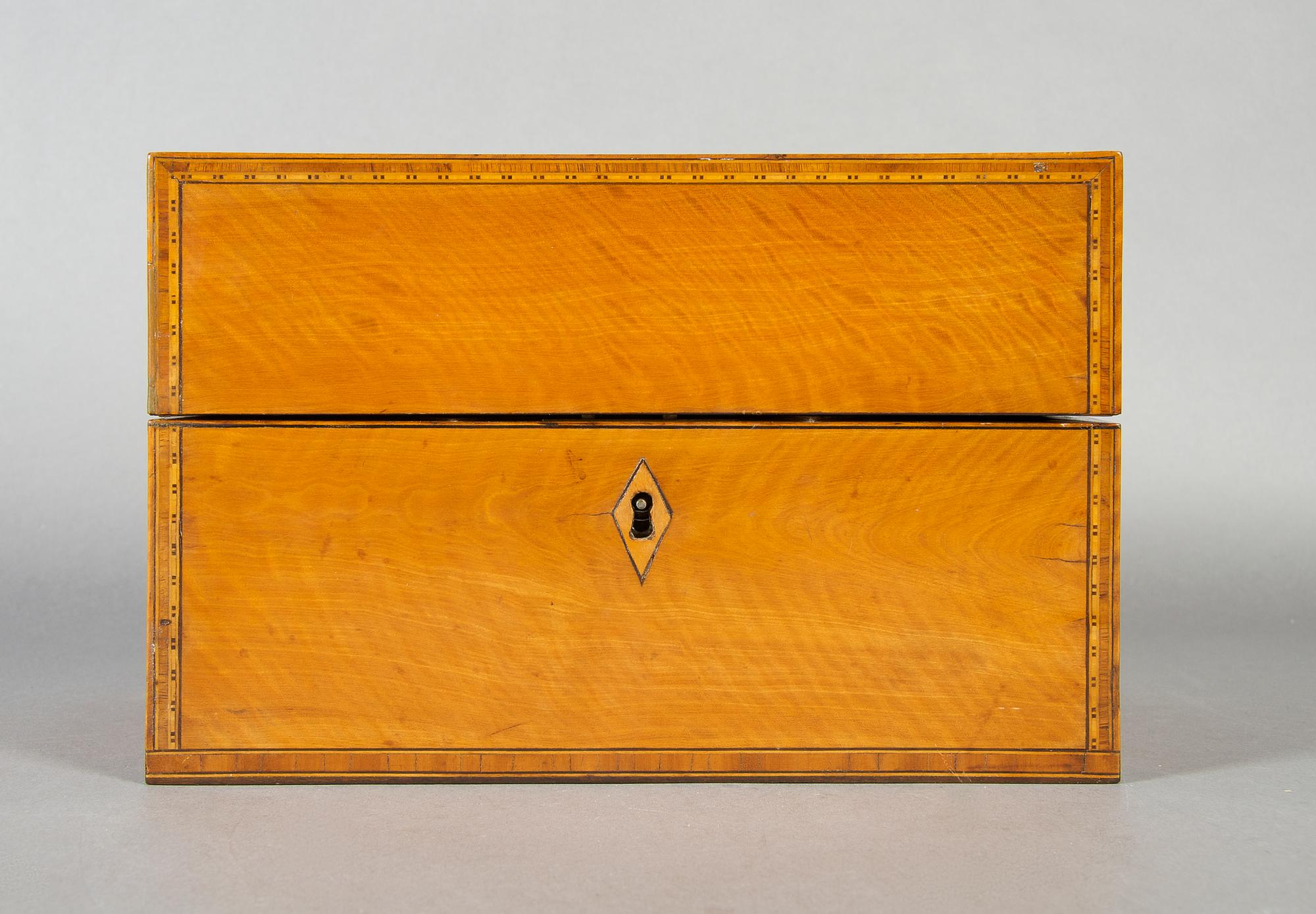 An English Satinwood and Walnut Tea Caddy, Height 6 1/8 x width 9 1/4 x depth 5 3/8 inches.