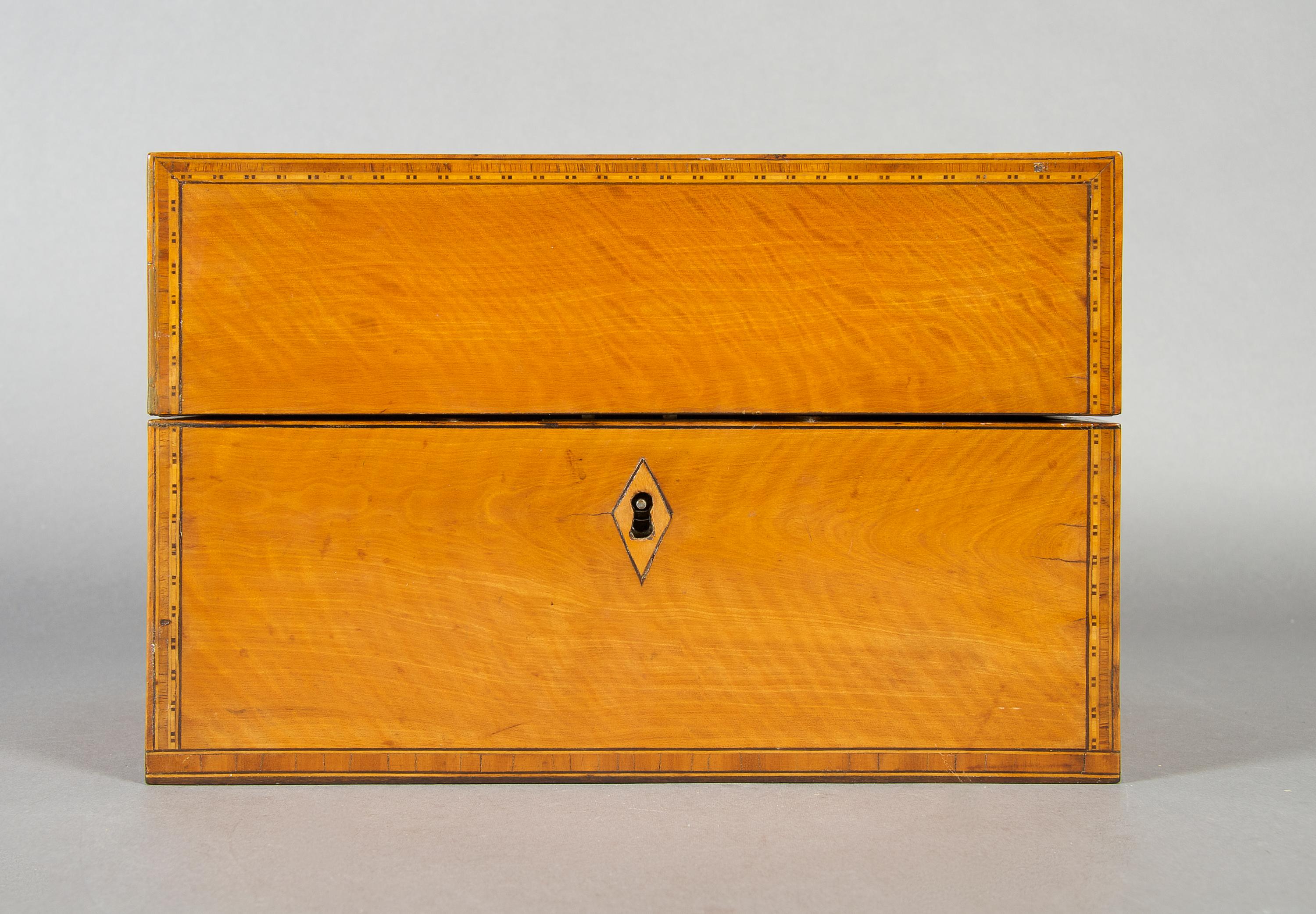 An English Satinwood and Walnut Tea Caddy, Height 6 1/8 x width 9 1/4 x depth 5 3/8 inches.