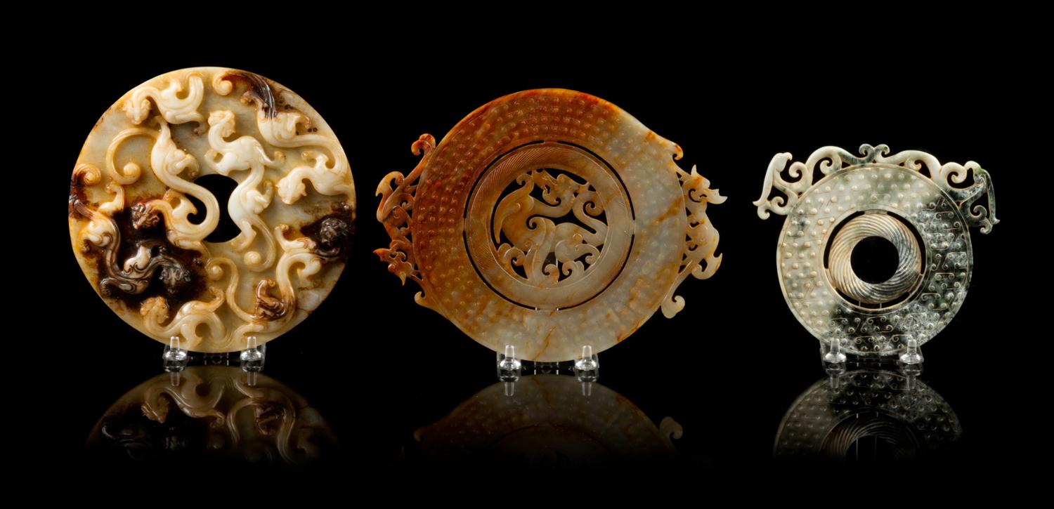 A Group of Seven Carved Jade Bi Discs Diameter of largest 9 inches.