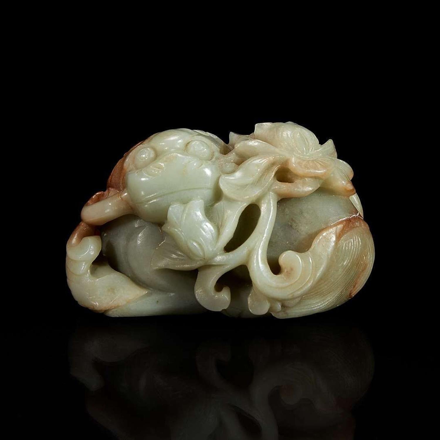 A Chinese greyish-celadon and russet jade recumbent beast and lotus group 青玉雕瑞兽衔荷花 18th century or earlier ???????