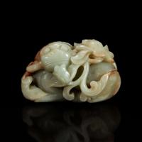 A Chinese greyish-celadon and russet jade recumbent beast and lotus group 青玉雕瑞兽衔荷花 18th century or earlier ???????